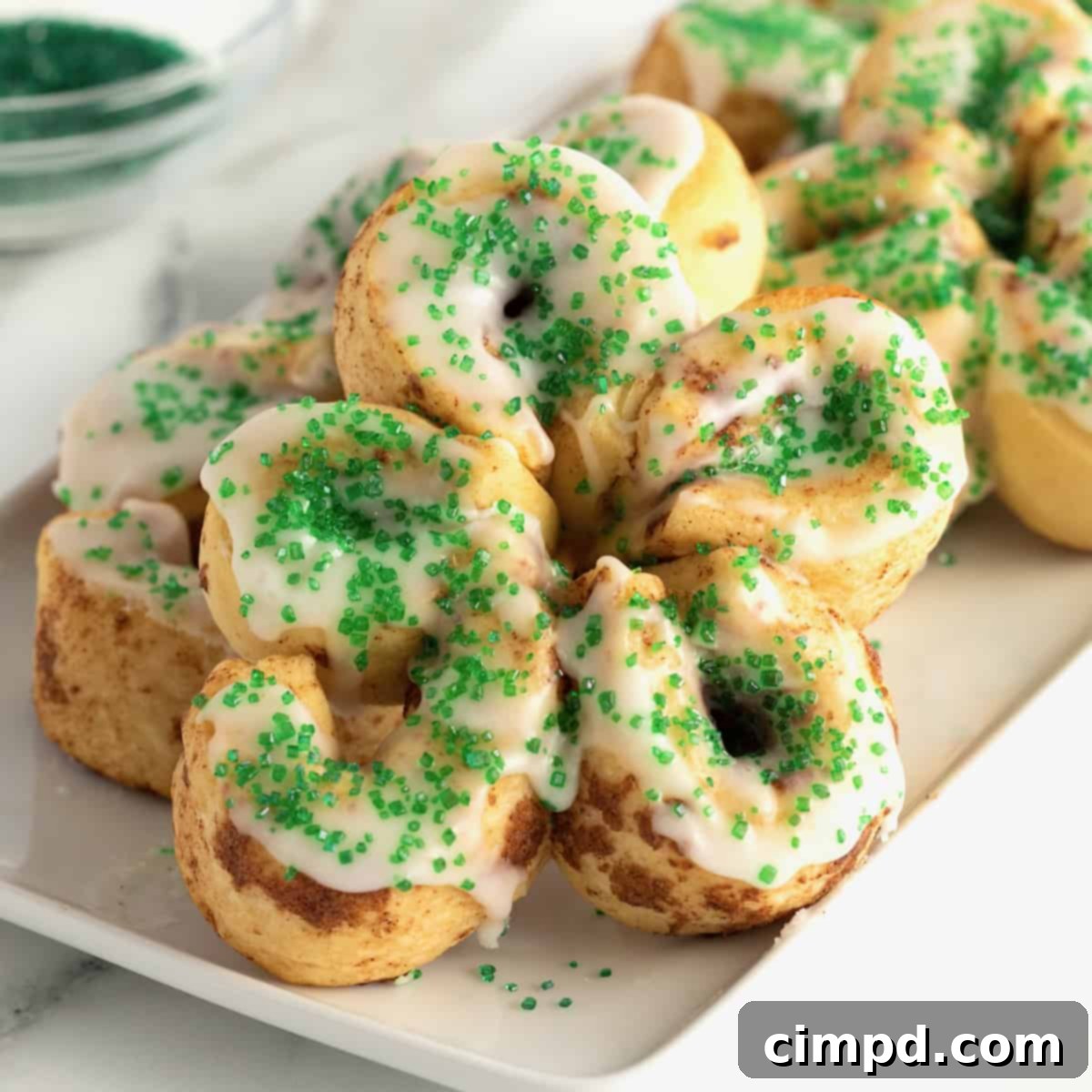 Close-up of baked St. Patrick's Day Cinnamon Rolls on a white plate, ready to be enjoyed
