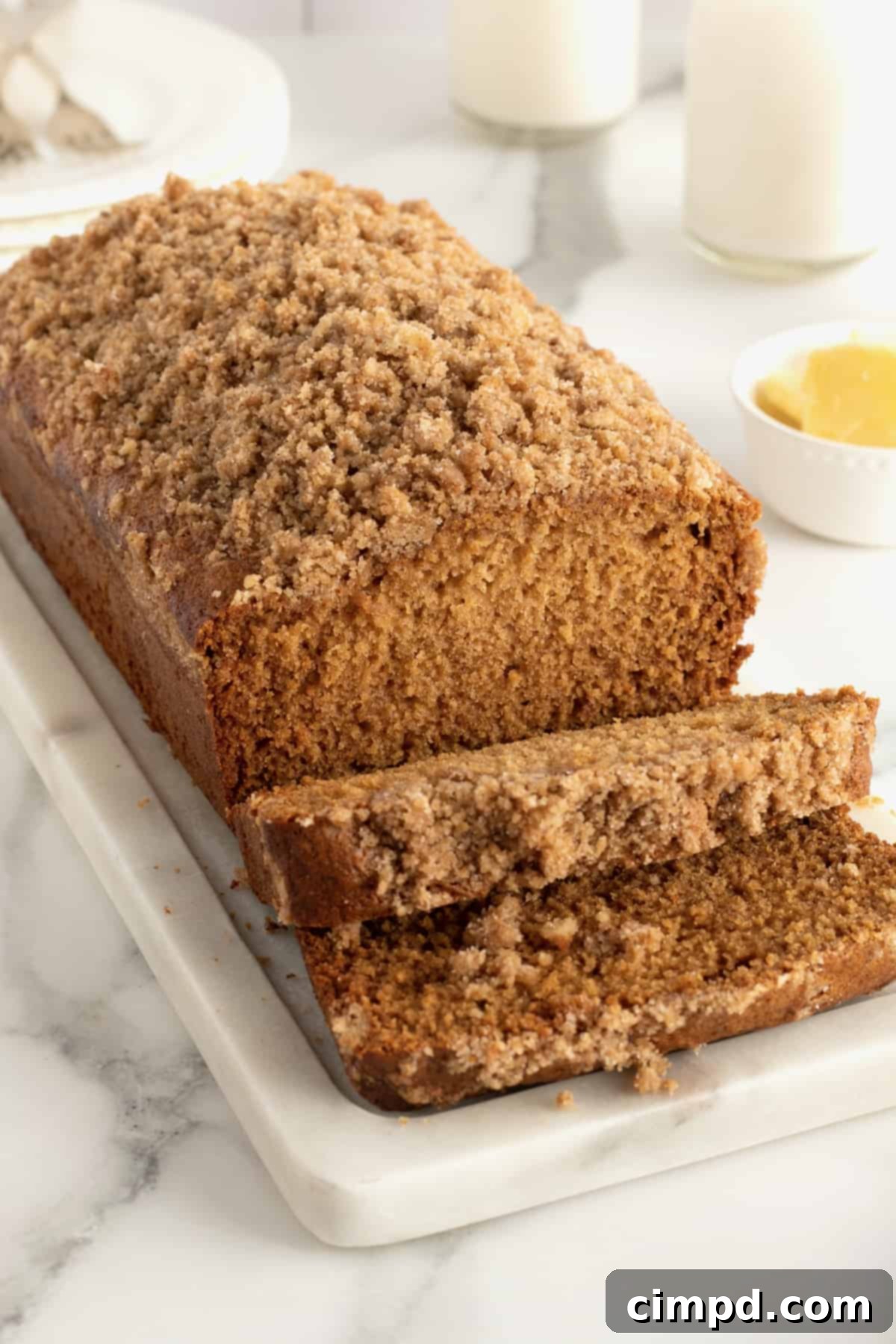 Golden-brown Maple Cinnamon Streusel Bread on a cooling rack, showcasing its crumbly streusel topping and inviting texture.