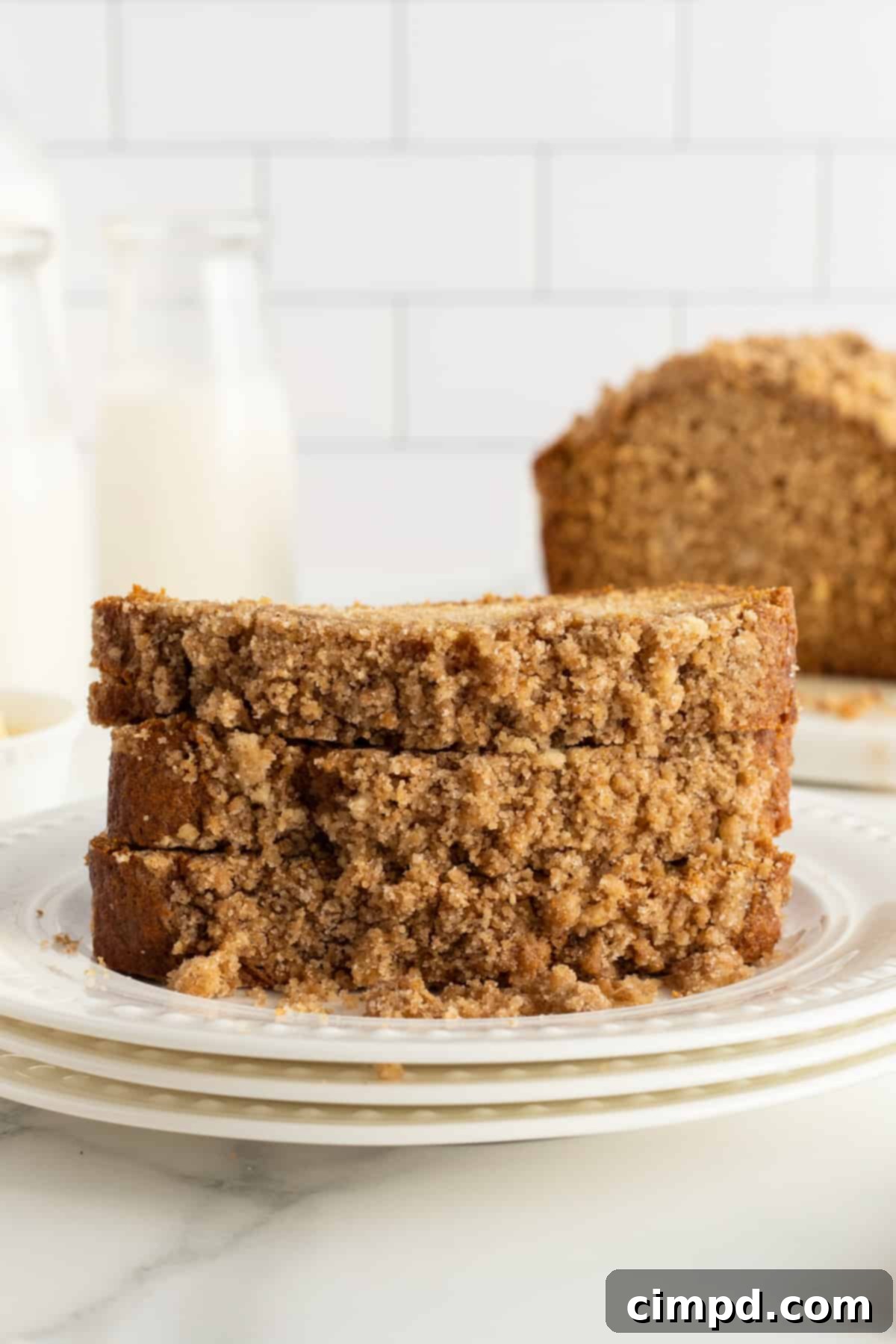 Close-up of a slice of Maple Cinnamon Streusel Bread, revealing the soft interior and distinct streusel topping.