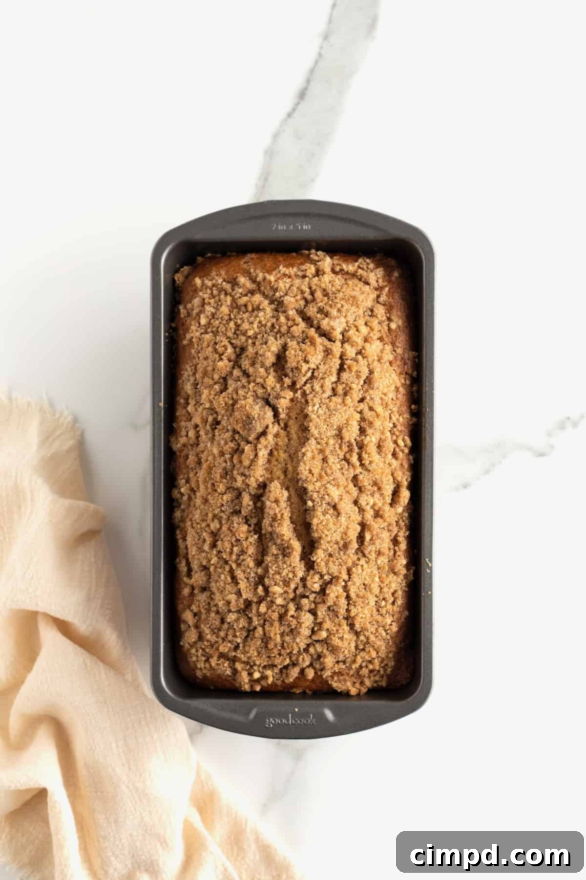 Freshly baked Maple Cinnamon Streusel Bread, golden brown with a perfect streusel crust, just out of the oven.