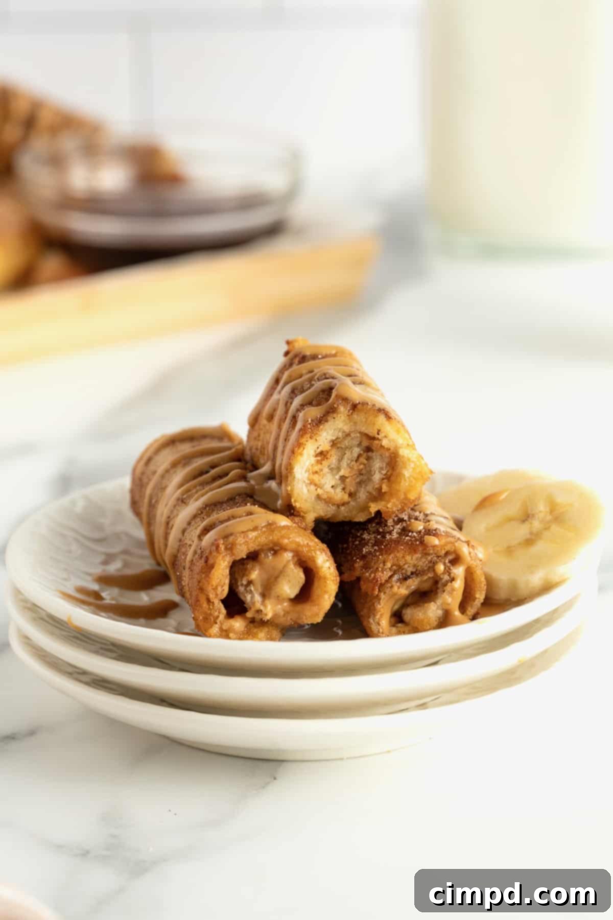 A close-up of a Peanut Butter Banana French Toast Roll Up with visible filling and cinnamon sugar coating.