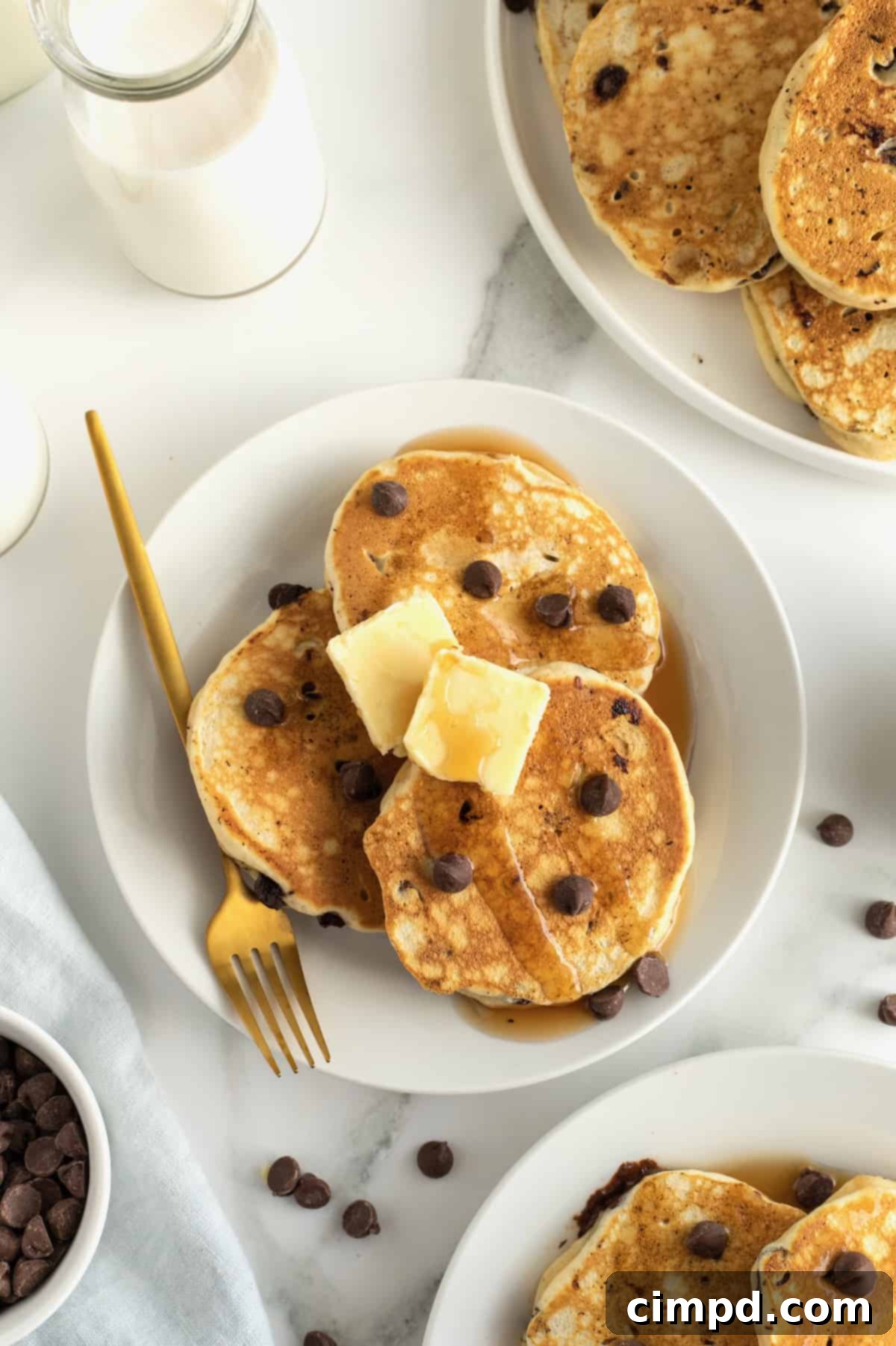 Stack of fluffy chocolate chip pancakes with syrup