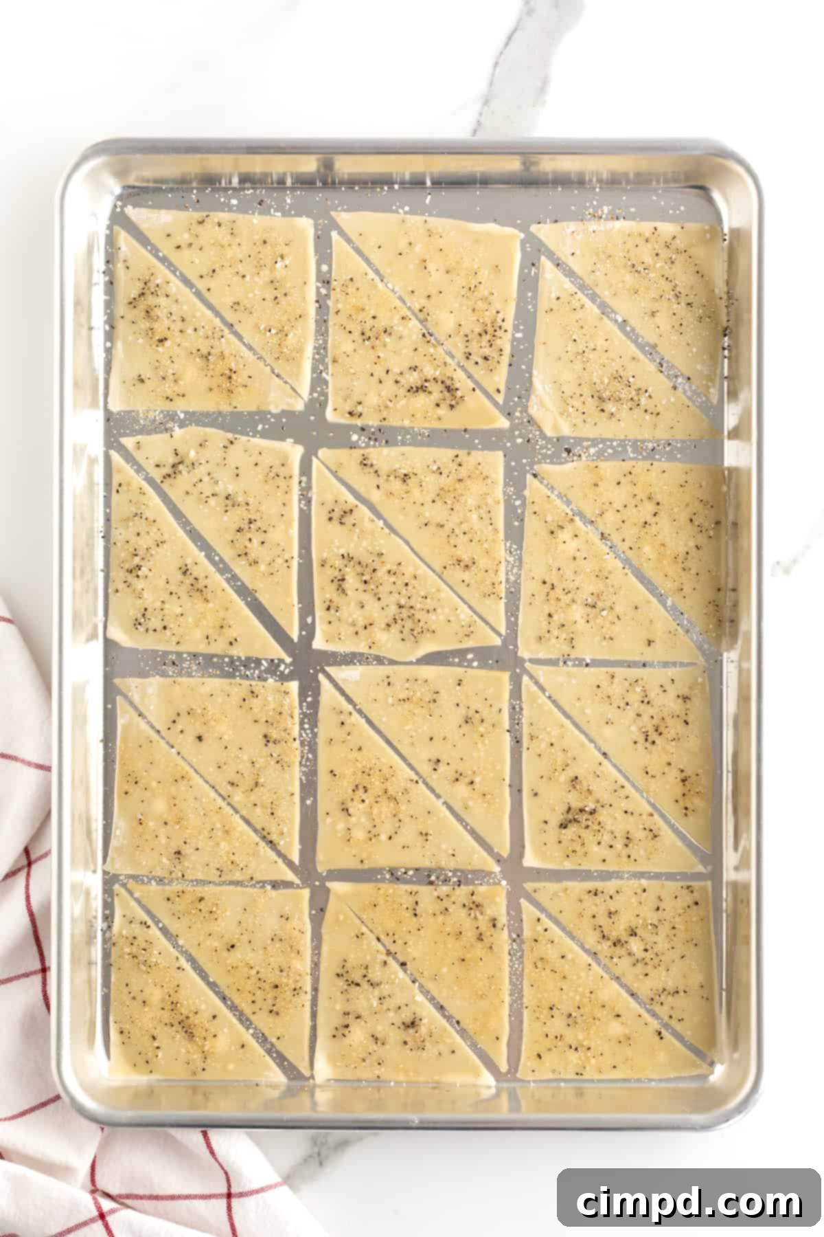 Step-by-step: sprinkling seasoning mixture over wonton chips