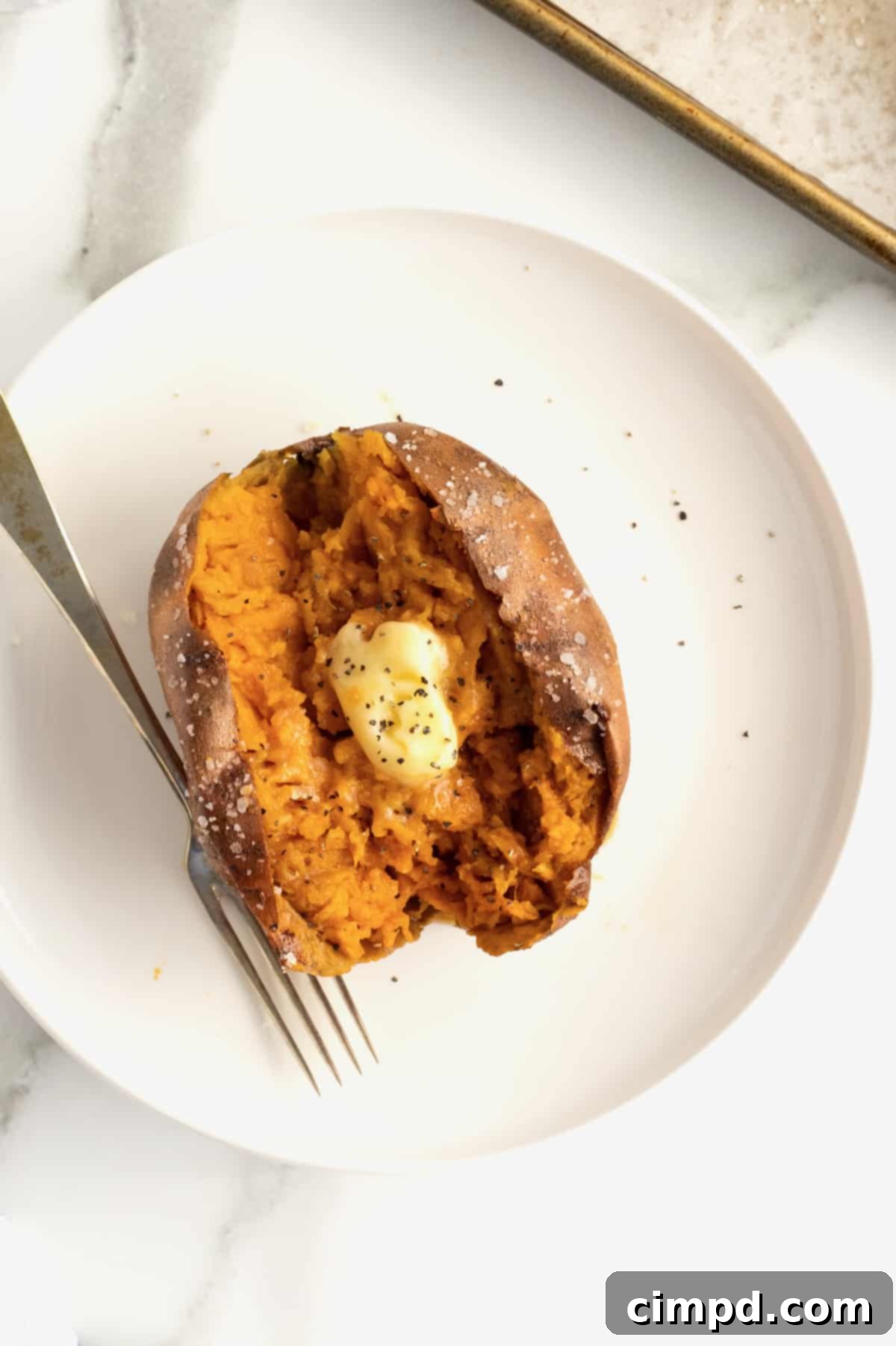 Perfect Baked Sweet Potatoes 3 How to Bake a Sweet Potato by The BakerMama - Close up of a split baked sweet potato with steam rising.