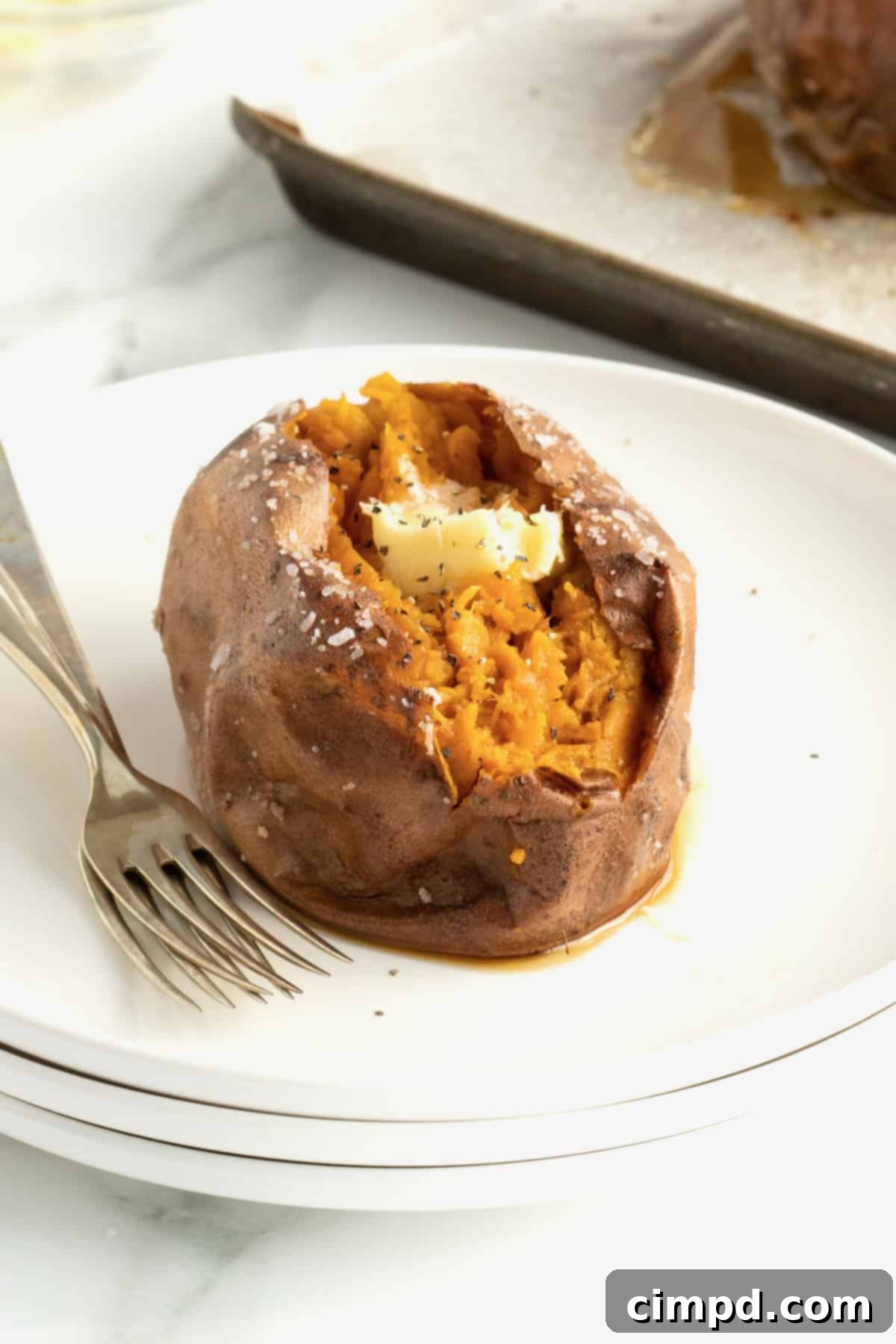 Perfect Baked Sweet Potatoes 4 How to Bake a Sweet Potato by The BakerMama - A stack of perfectly baked sweet potatoes.