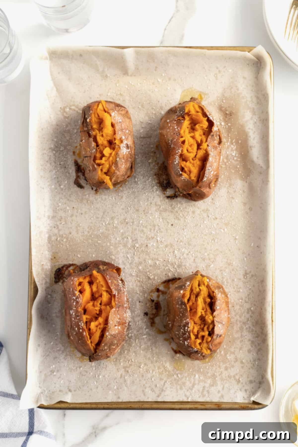 Perfect Baked Sweet Potatoes 5 How to Bake a Sweet Potato by The BakerMama - Sweet potatoes pierced and ready for oil and salt.