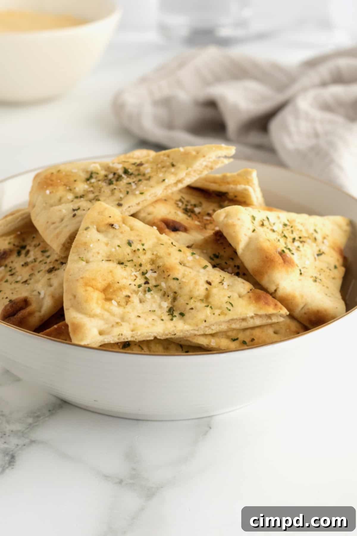 Crispy homemade Baked Pita Chips arranged beautifully for dipping