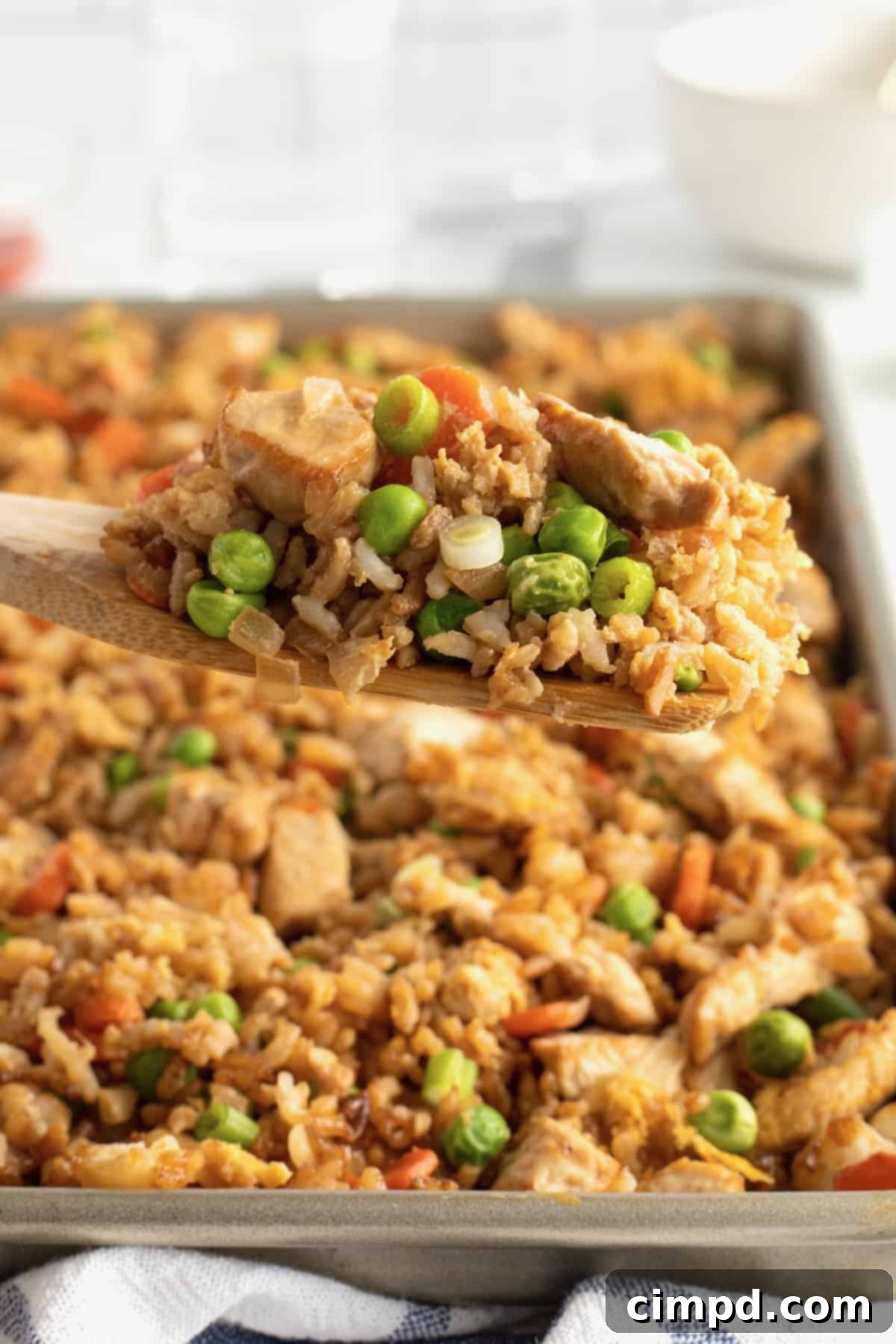 Overhead shot of Sheet Pan Chicken Fried Rice cooking on a baking sheet