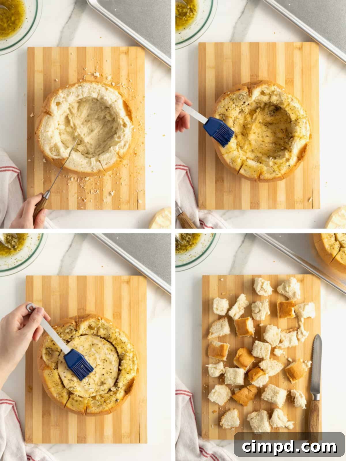Sourdough loaf hollowed out on a wooden cutting board.