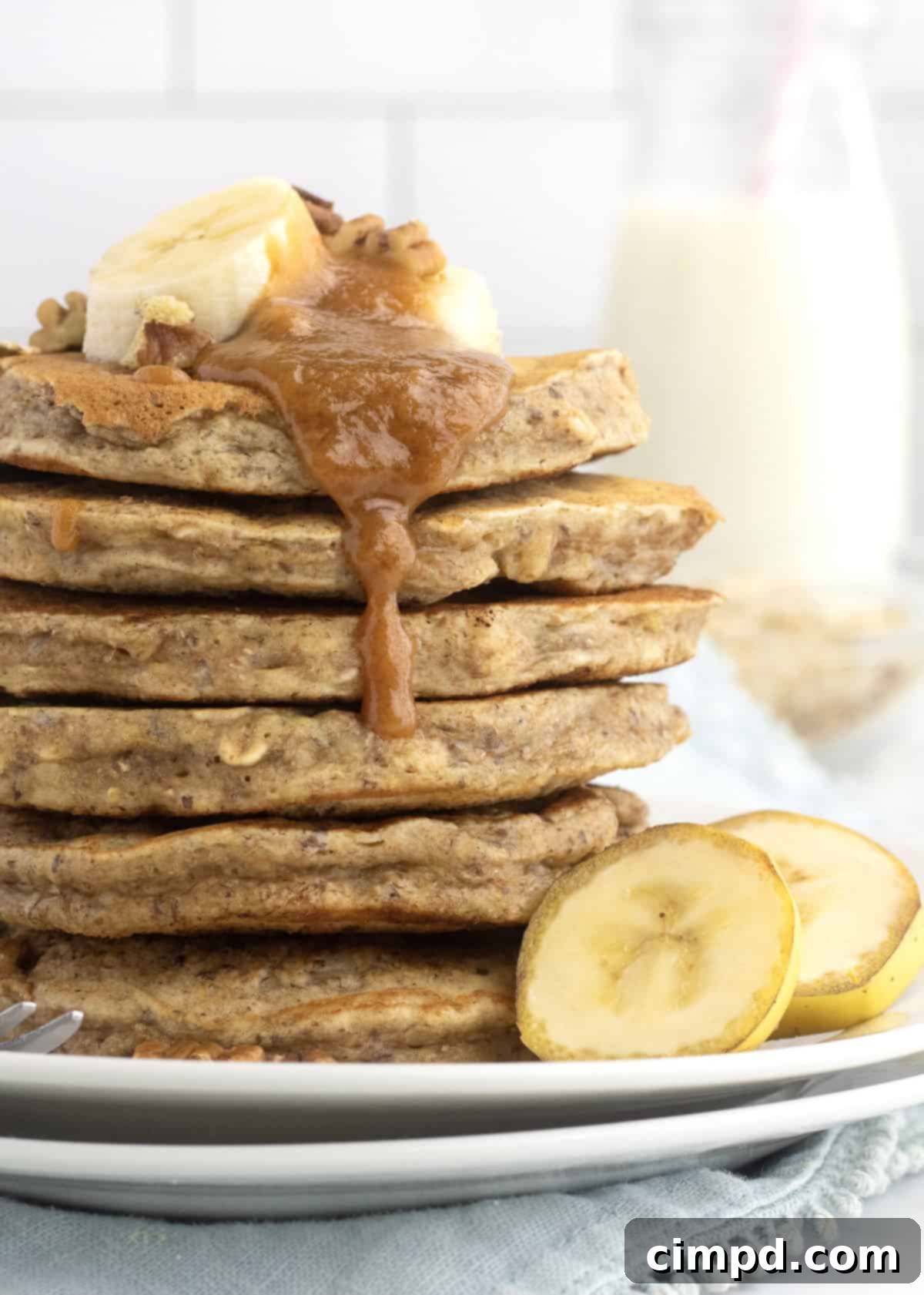 Wholesome Banana Nut Oat Pancakes 2 Delicious Whole Wheat Banana Nut Oat Pancakes by The BakerMama, topped with peanut butter maple syrup