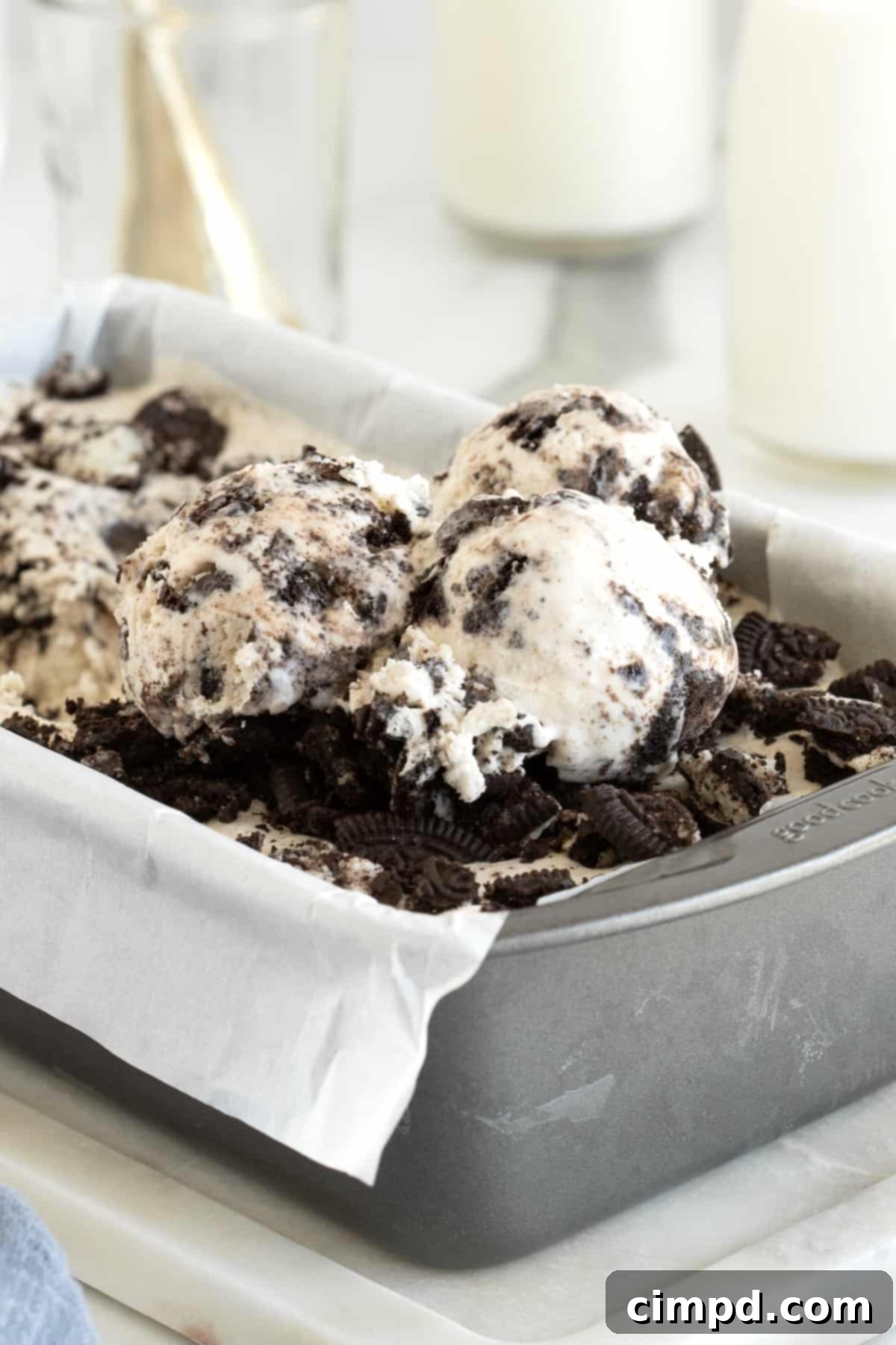 Black and White Bliss 2 Rich Cookies and Cream ice cream in a metal bread pan lined with parchment paper, ready to be served.