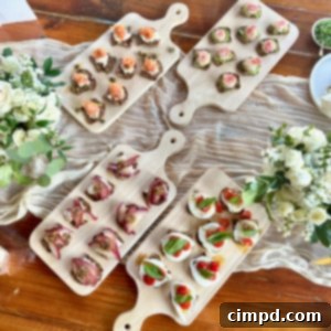 Four natural wood cutting boards with a variety of cracker bites.