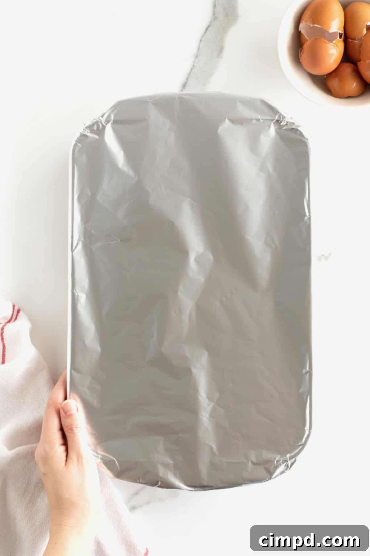 The baking dish covered tightly with aluminum foil, ready to go into the oven for the initial 30-minute bake.