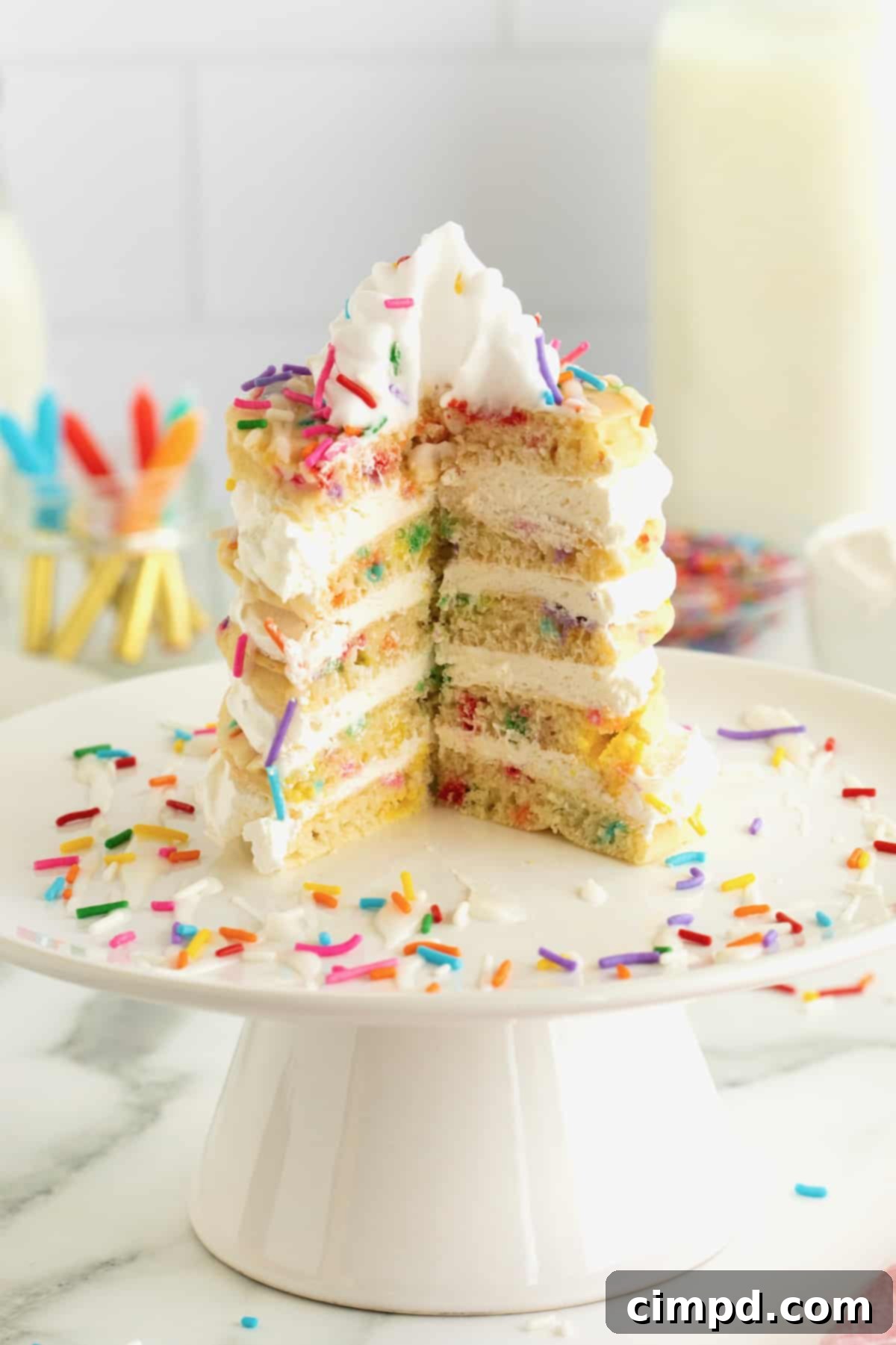 Celebration Pancake Stack 3 A slice cut out of a layer cake made from confetti pancakes.