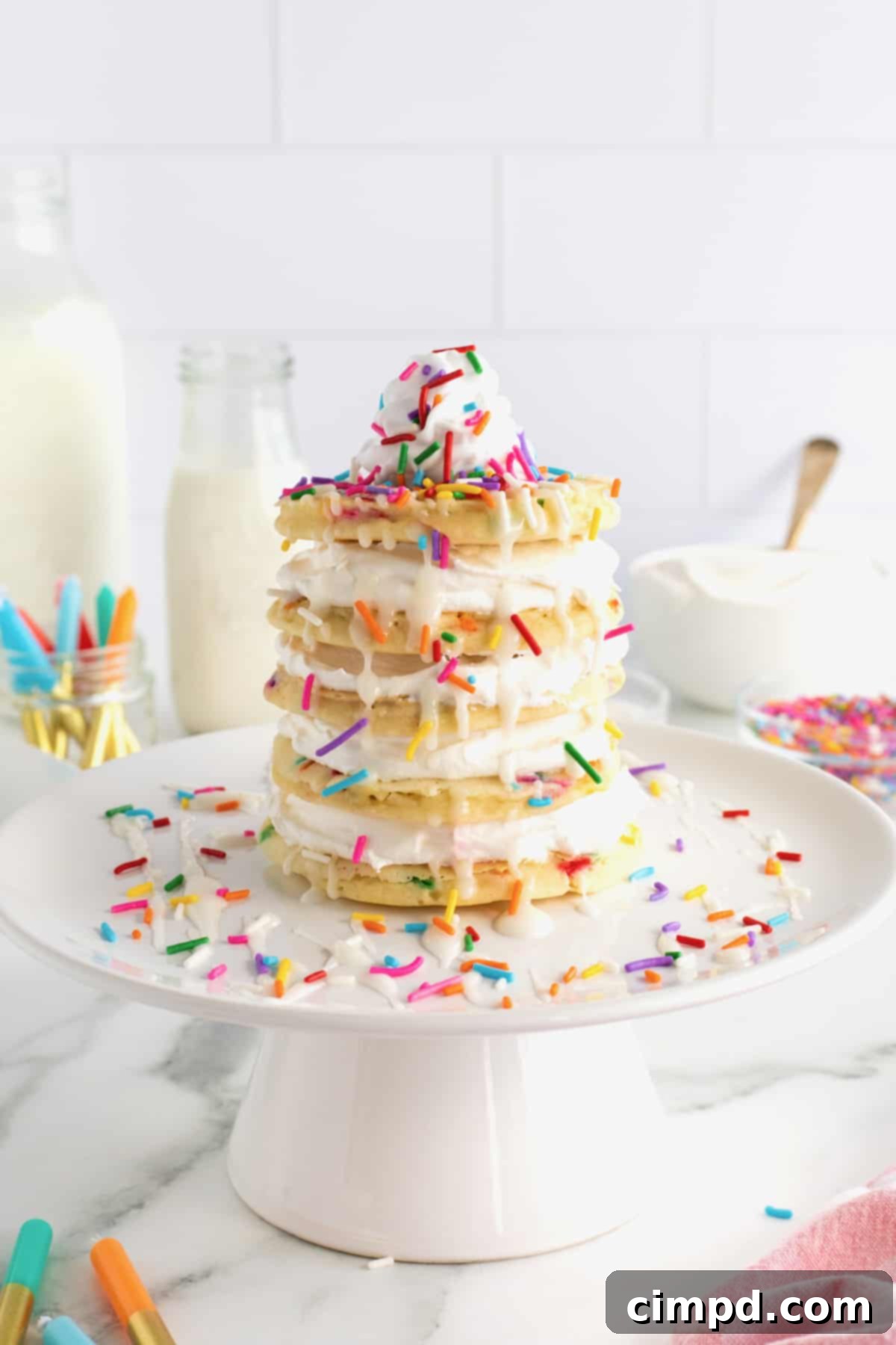 Celebration Pancake Stack 4 A layer cake made from confetti pancakes topped with whipped topping and rainbow sprinkles.