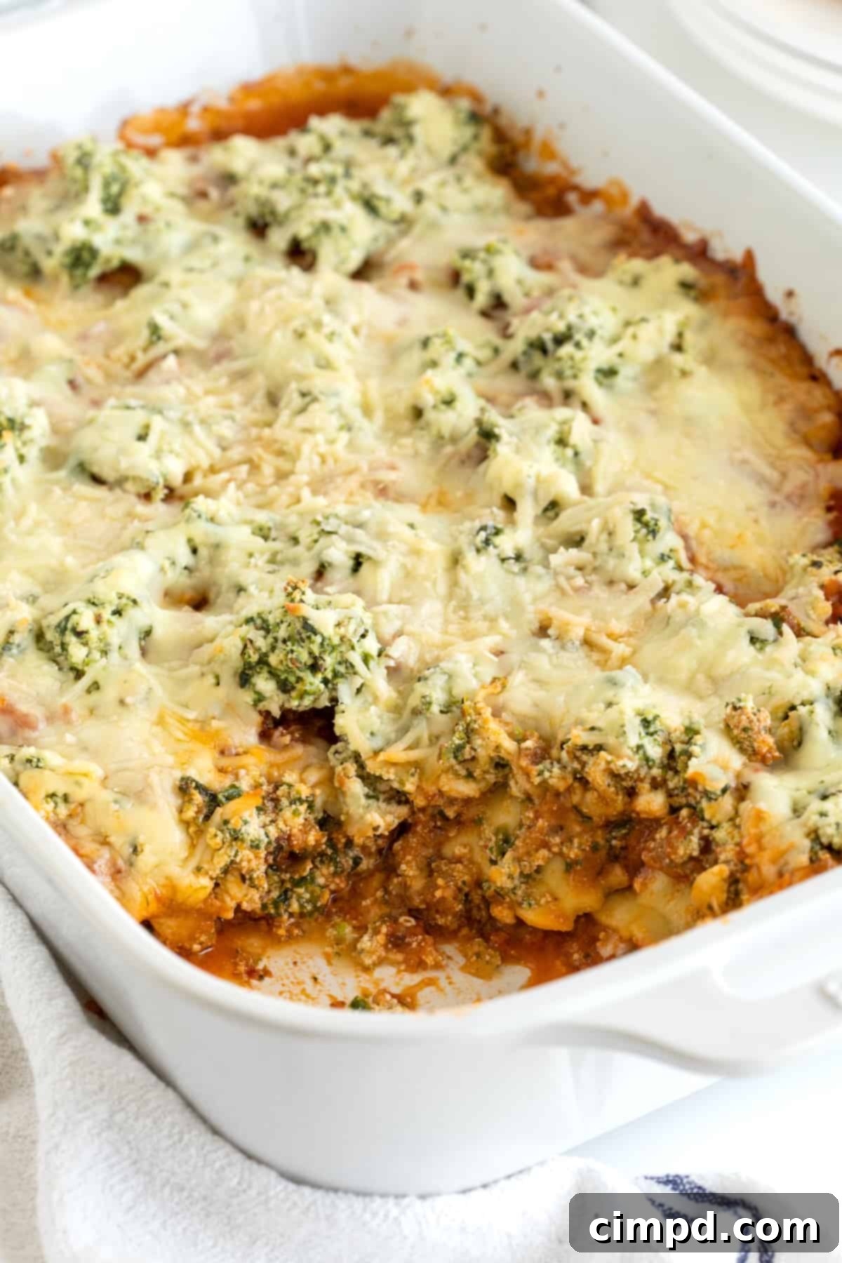 A white casserole dish with lasagna.