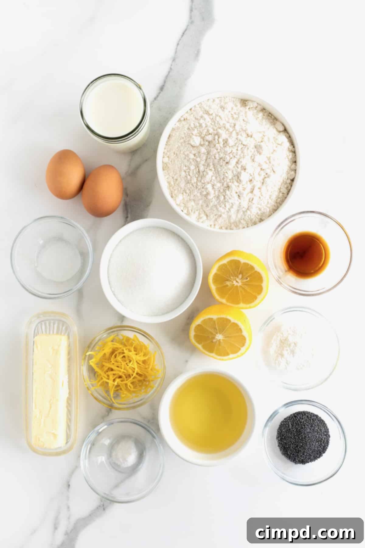 Zesty Lemon Poppy Seed Delights 6 All the dry and wet ingredients for lemon poppy seed muffins, meticulously arranged in small glass containers on a white marble counter.