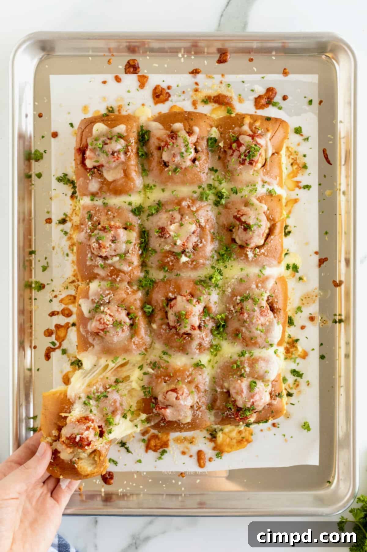 Delicious Meatball Stuffed Garlic Rolls freshly baked on a baking sheet, topped with marinara and melted mozzarella, ready to be served.