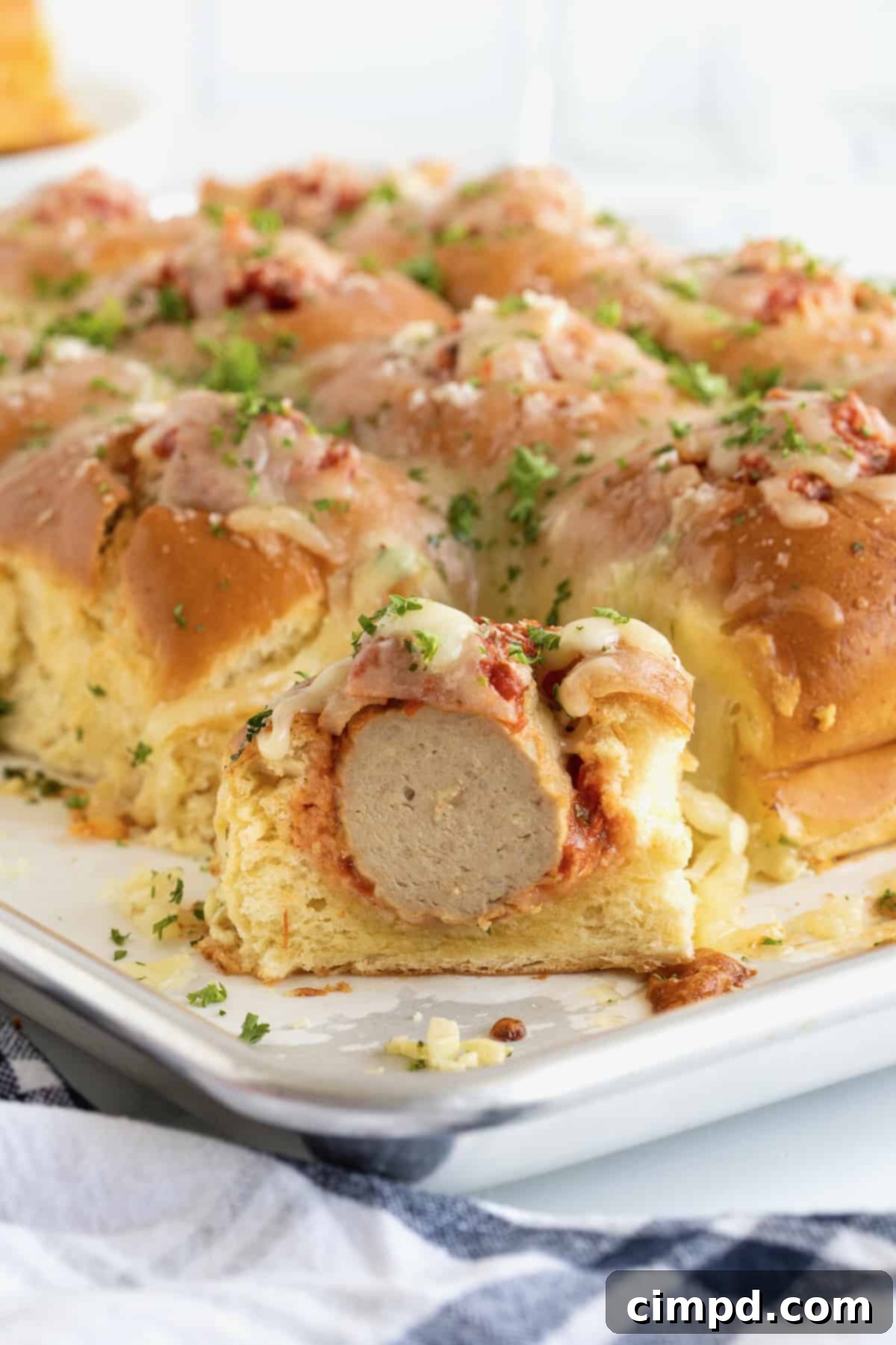Meatball Stuffed Garlic Rolls arranged beautifully on a serving platter, sprinkled with parsley, ready to be enjoyed as party food or dinner.