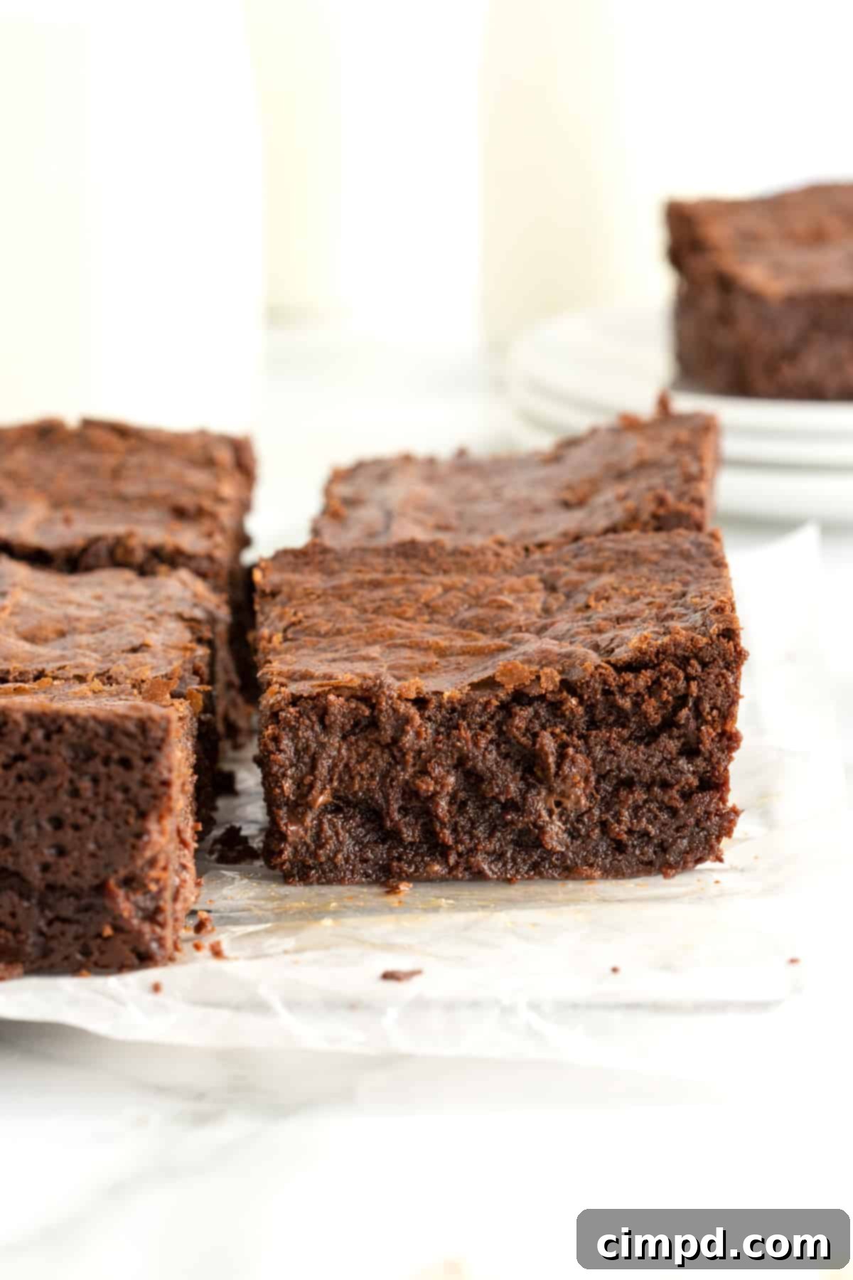 Moist and chewy brownies on a parchment lined cooling rack.