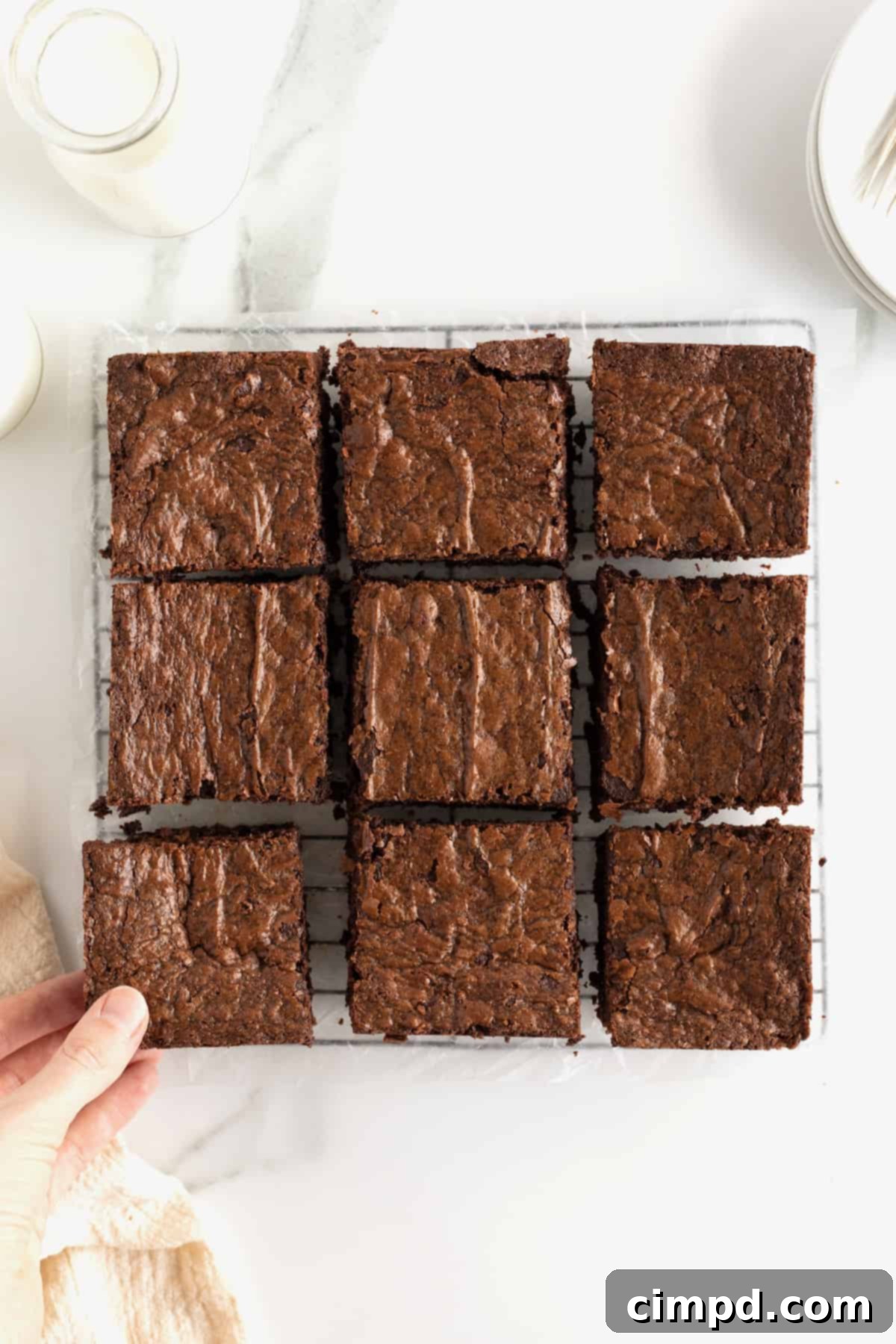 Nutella brownies with a crackly top cut into nine squares.