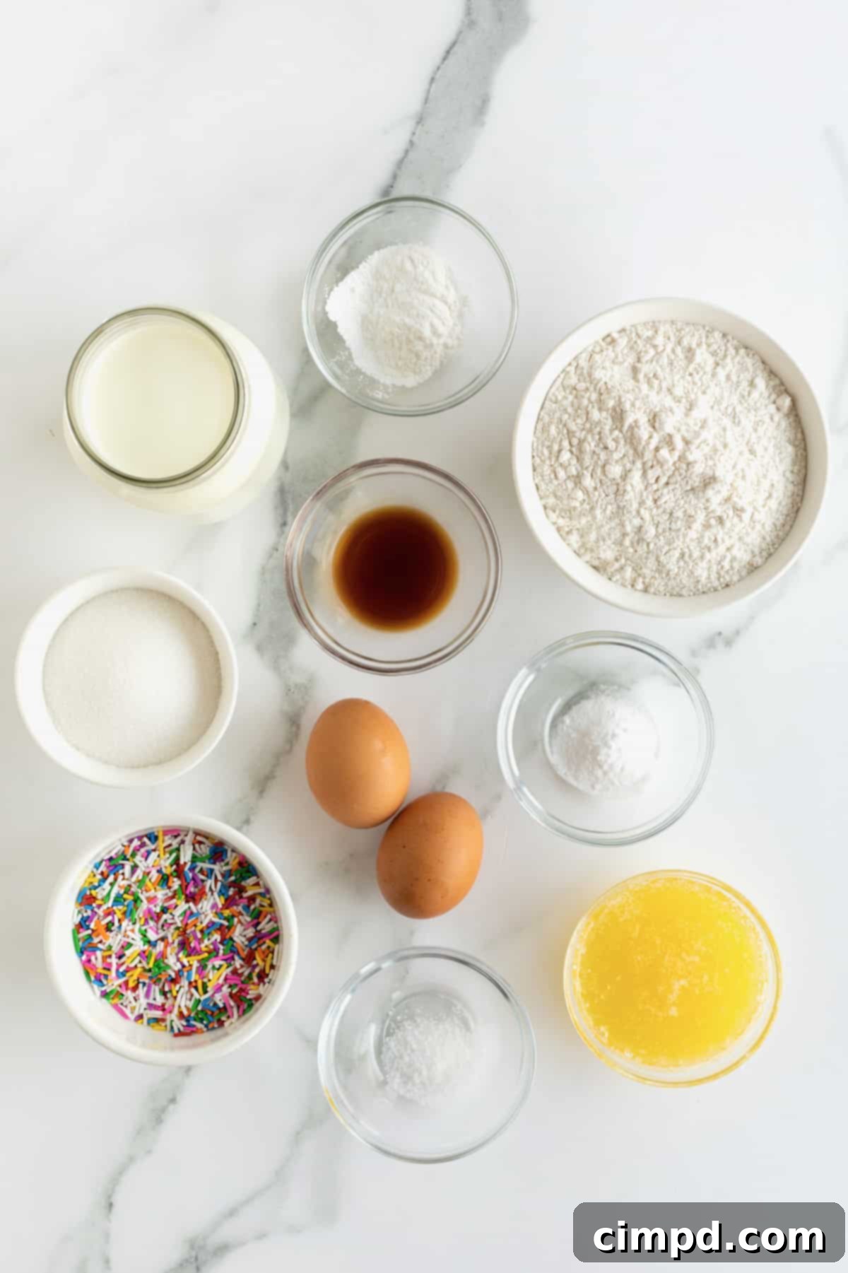 Flour, sugar, eggs, vanilla extract, milk, melted butter and rainbow sprinkles.