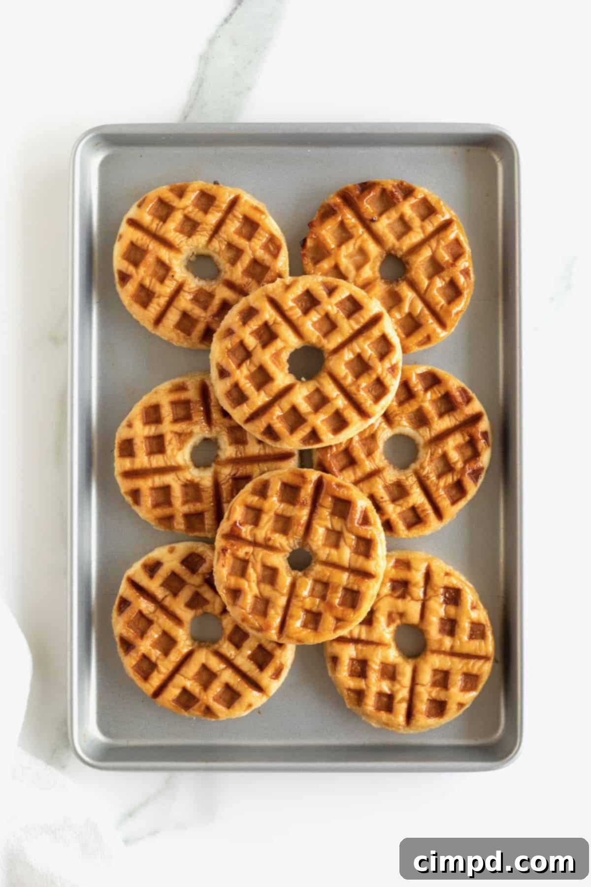 Glazed Waffle Rings 10 A baking tray filled with 8 hot donut waffles, perfectly golden and ready to be served.