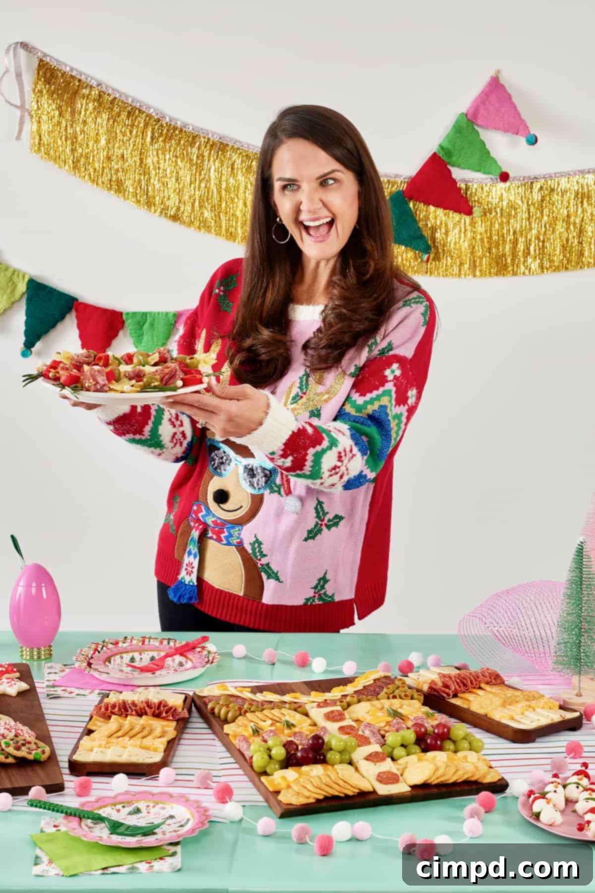 A woman smiling cheerfully, adorned in a festive Christmas sweater featuring a reindeer wearing stylish glasses. Her joyful expression captures the lighthearted and fun spirit of an Ugly Sweater Holiday Party.