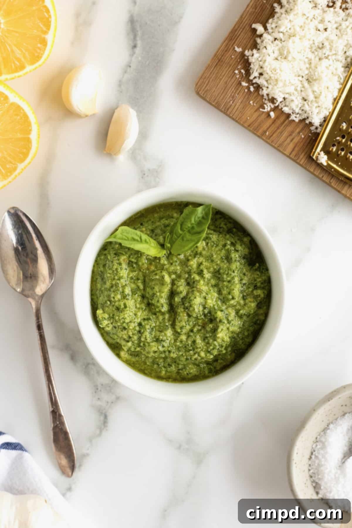 Crafting Your Own Fresh Basil Pesto 3 A white ceramic dish filled with pesto, beautifully garnished with fresh basil leaves.