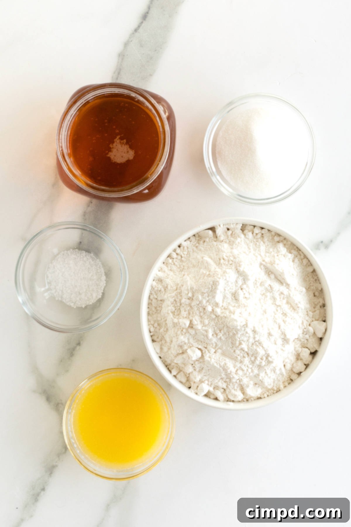 Pub-Style Beer Bread 7 A selection of ingredients for making beer bread: self-rising flour, sugar, kosher salt, melted unsalted butter, and a bottle of beer.