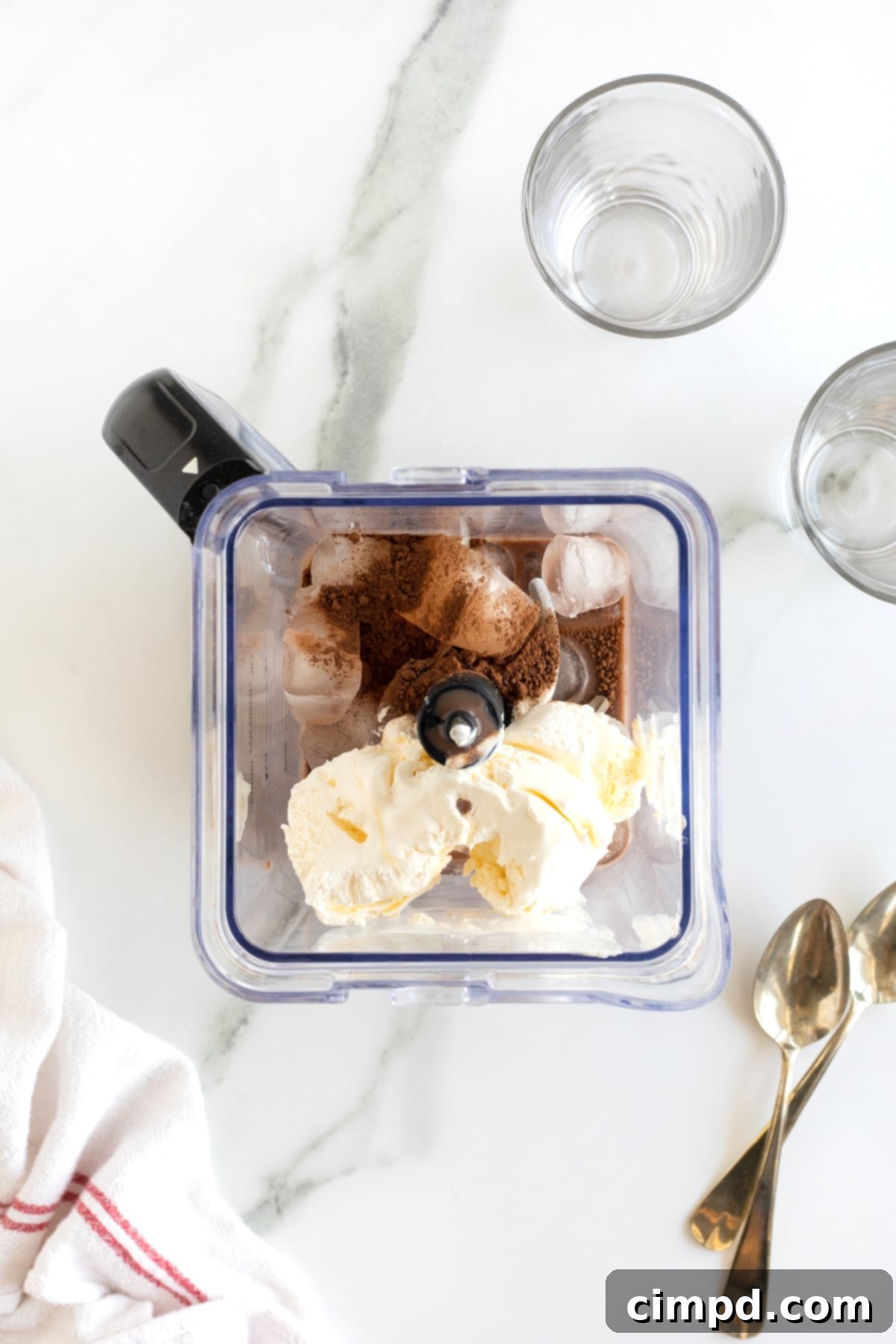 All ingredients for a homemade Wendy's Frosty perfectly measured and placed inside a powerful blender, ready to be transformed into a delicious frozen treat.