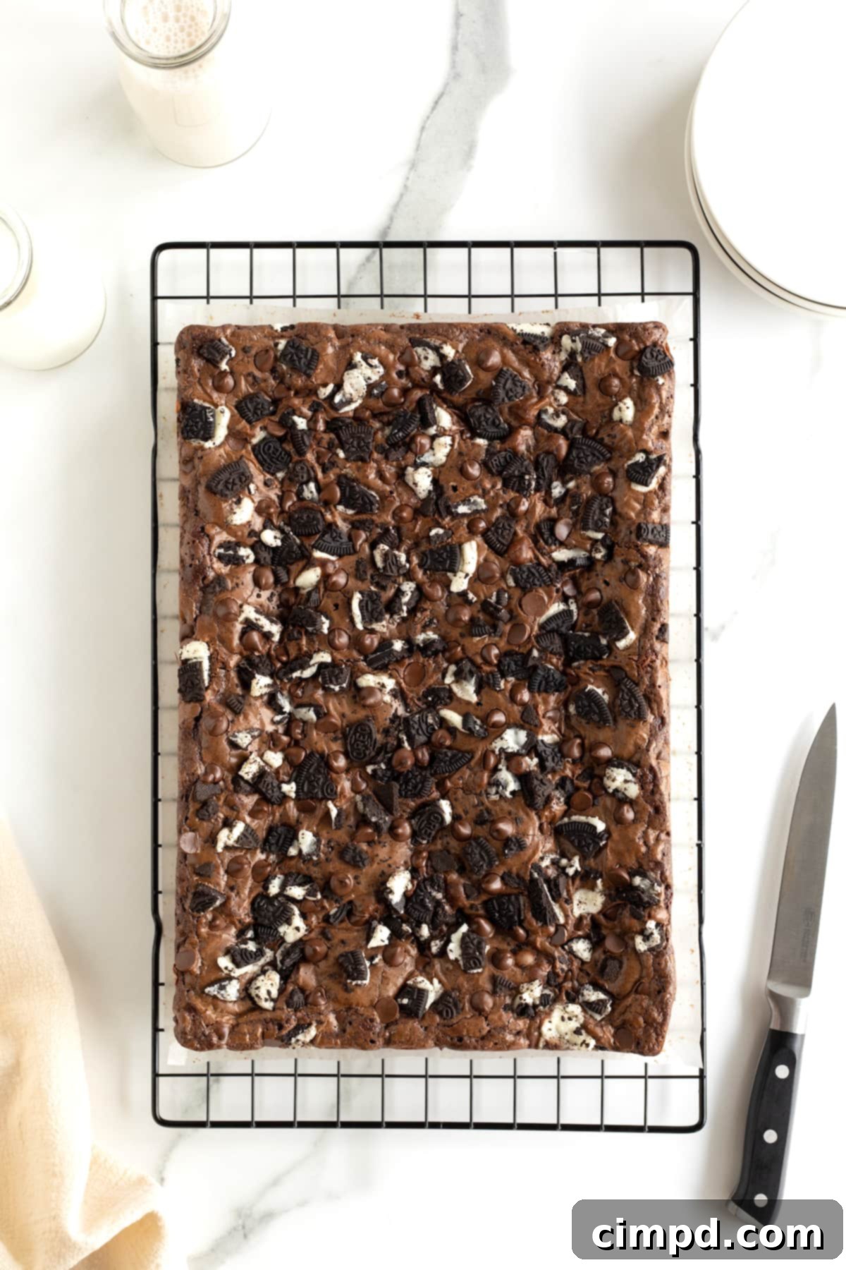 Individual three-layer brownies on a parchment-lined cooling rack, ready to be served.