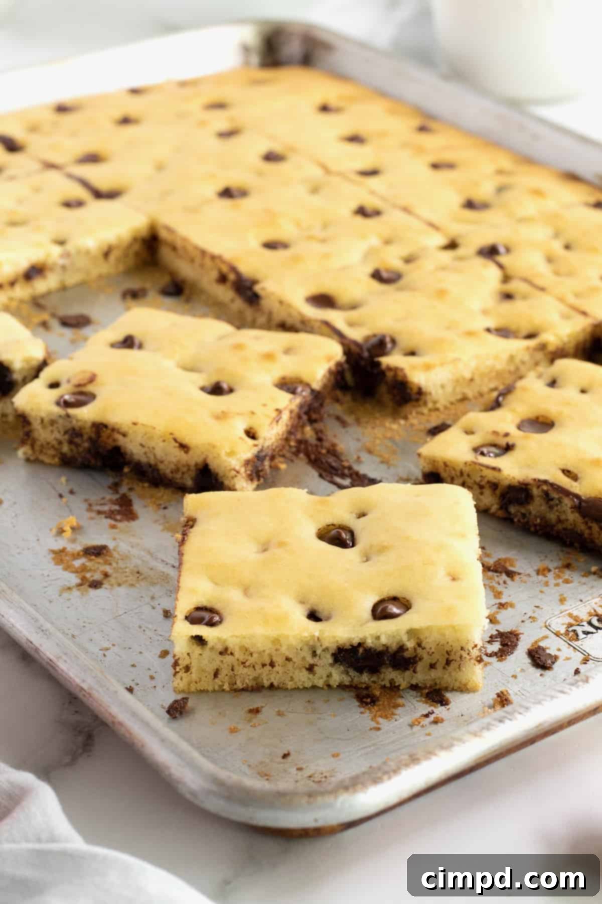 An aluminum sheet pan with square cut chocolate chip pancakes.