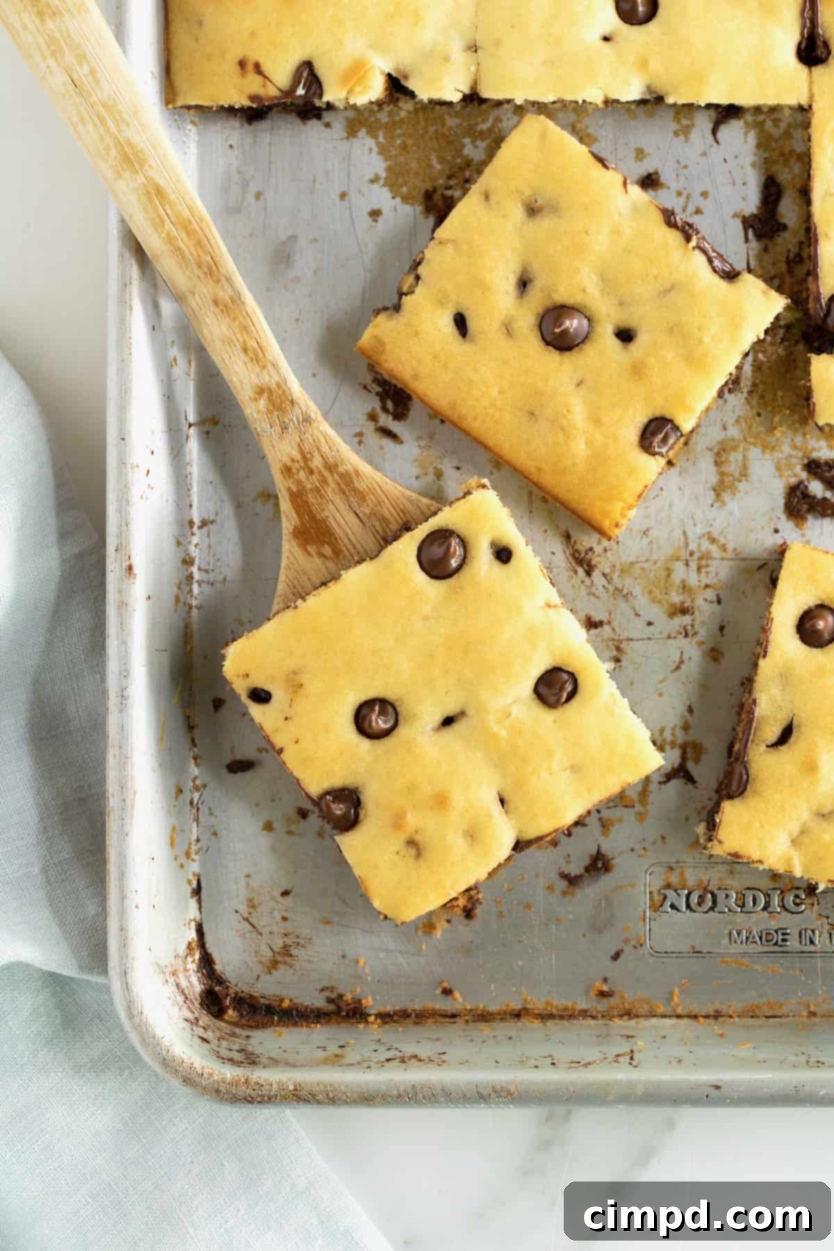 An aluminum sheet pan with square cut chocolate chip pancakes.