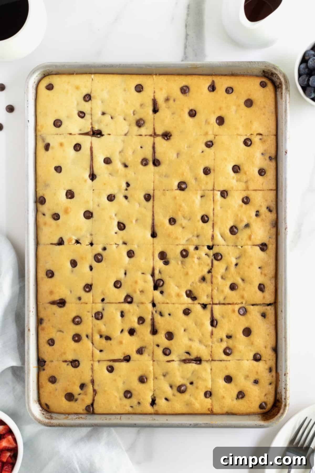 A sheet pan of chocolate chip sheet pan pancakes cut into squares.