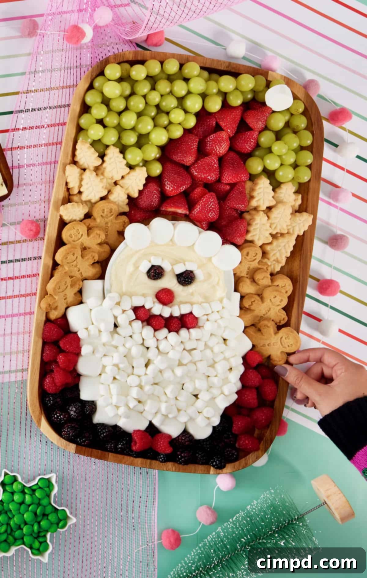 The completed Santa Sweets Board, meticulously arranged with colorful fruits, fluffy marshmallows, and festive cookies, ready for a holiday celebration.