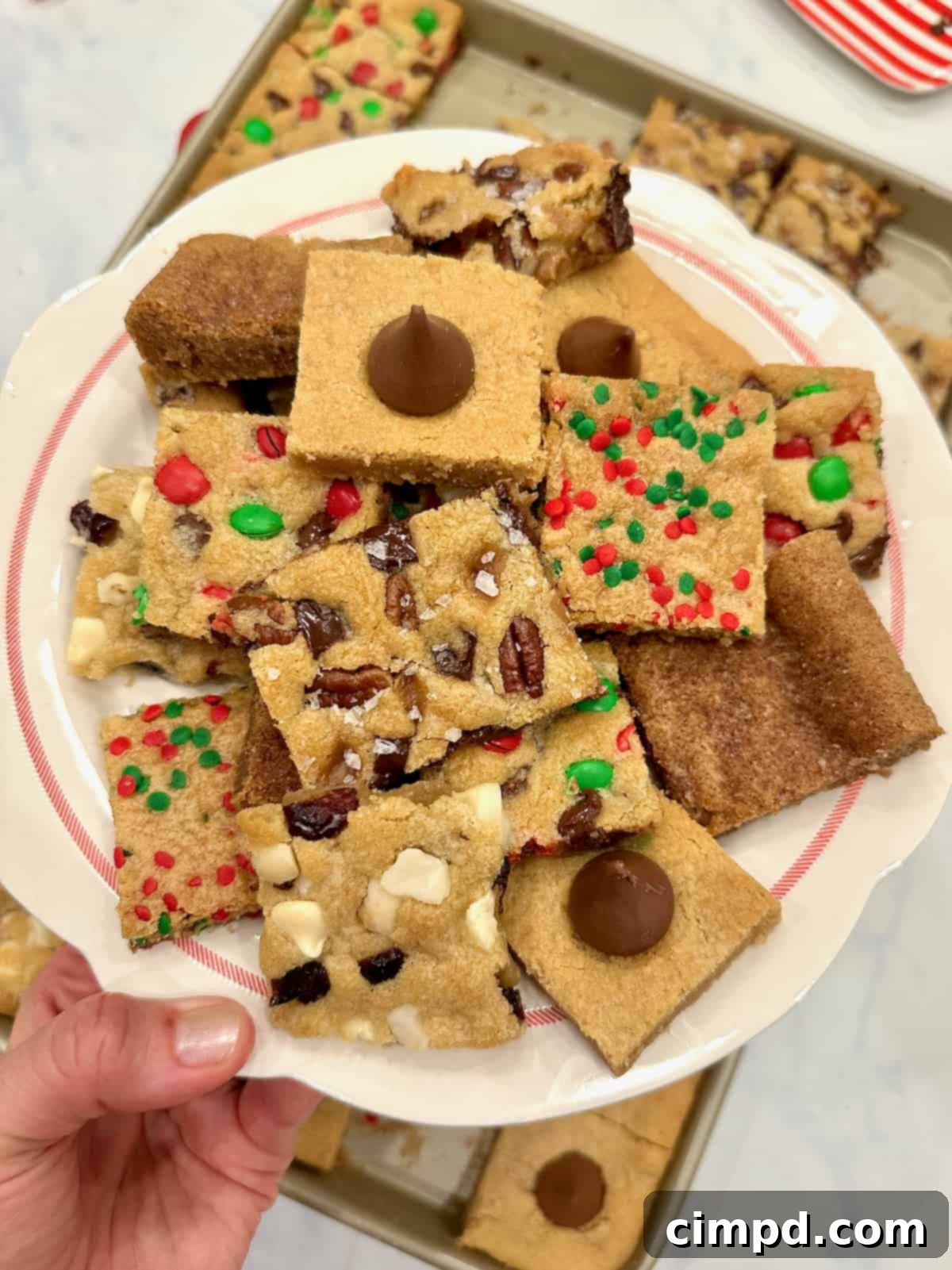 A beautifully arranged plate brimming with a variety of holiday cookie bars, showcasing their diverse textures and toppings.