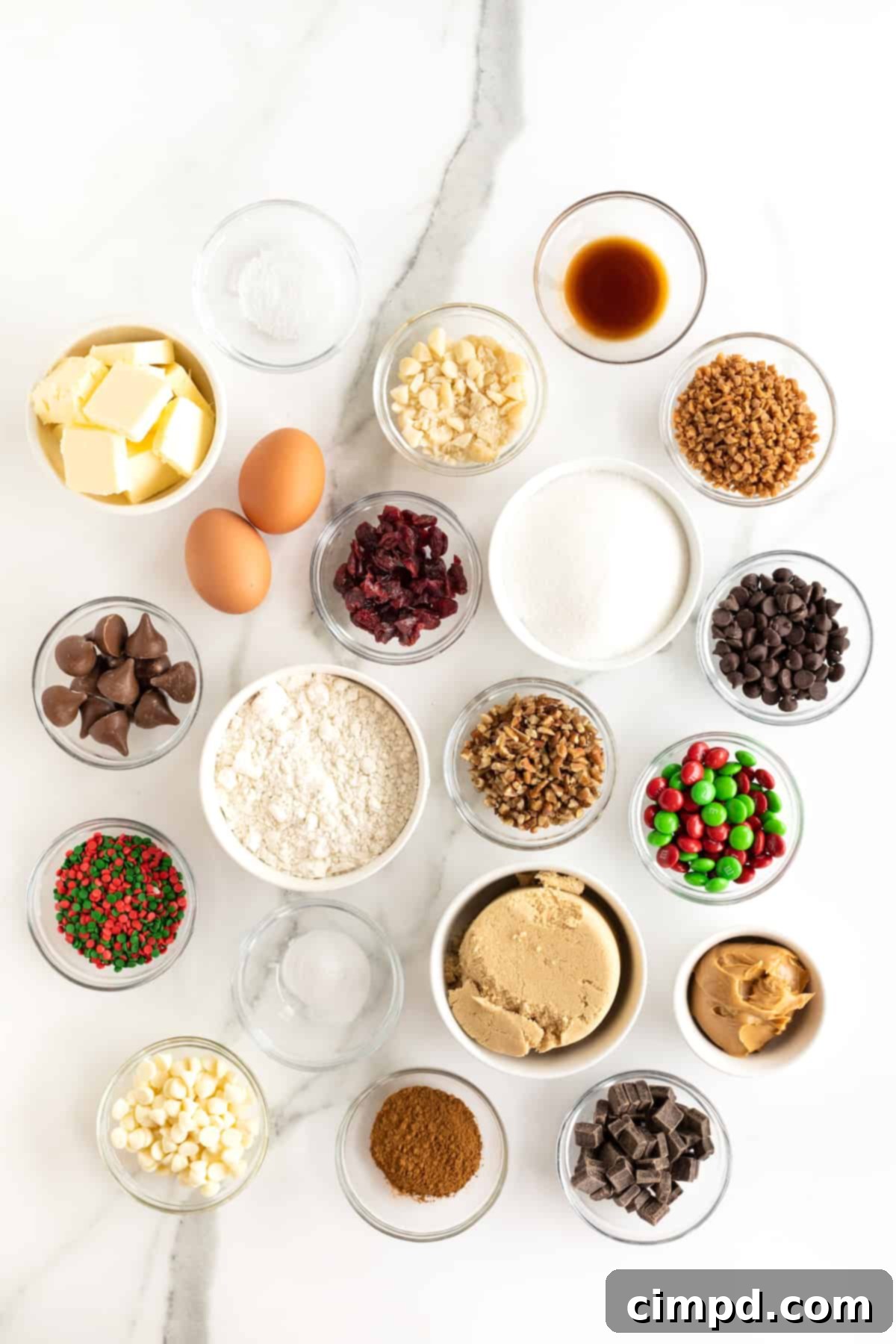 Various ingredients for Holiday Cookie Bars, meticulously portioned into small glass dishes and arranged neatly on a elegant white marble countertop, ready for mixing.