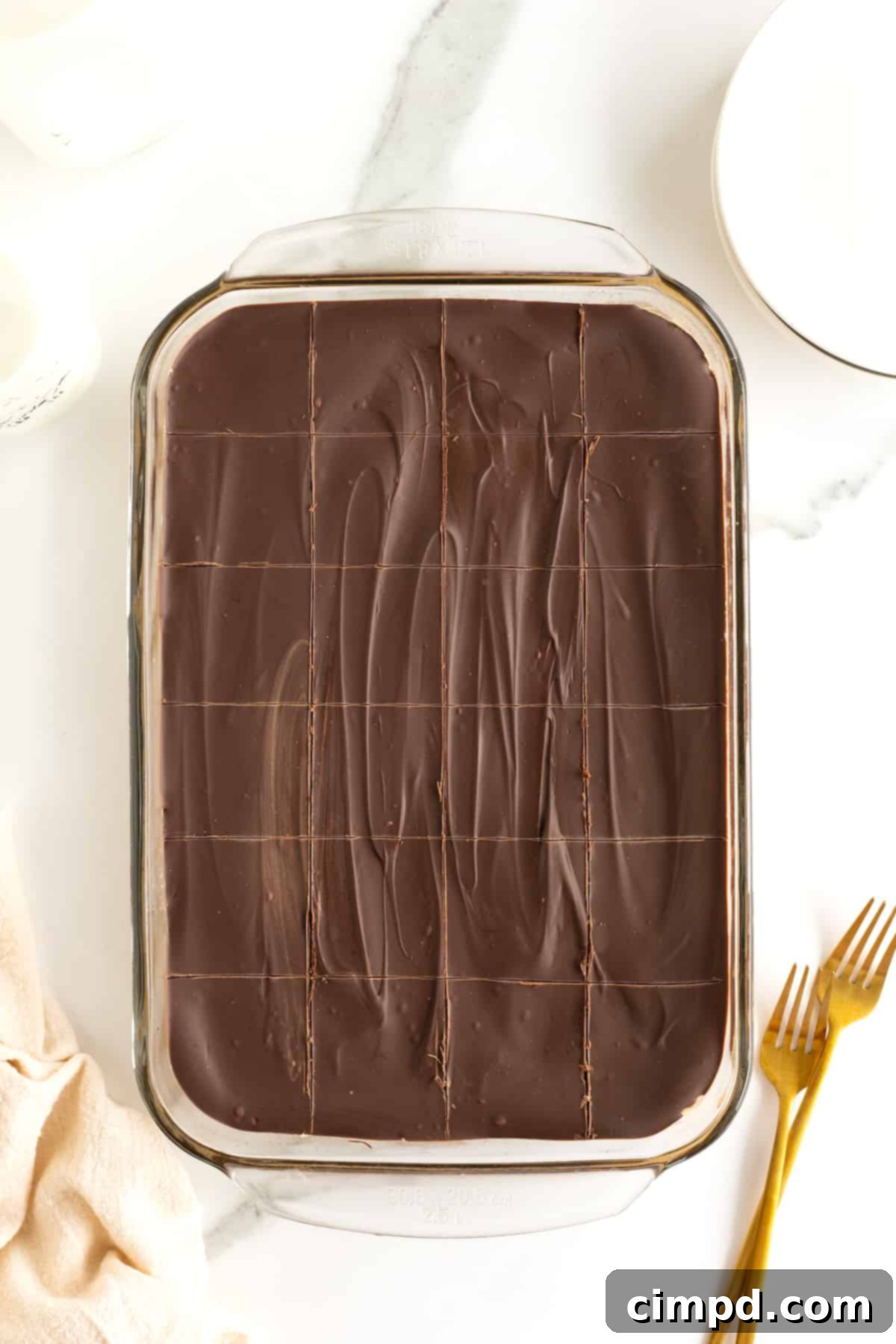 No Bake Peanut Butter Chocolate Bliss 8 A glass baking dish with chocolate covered peanut butter bars cut into even squares.