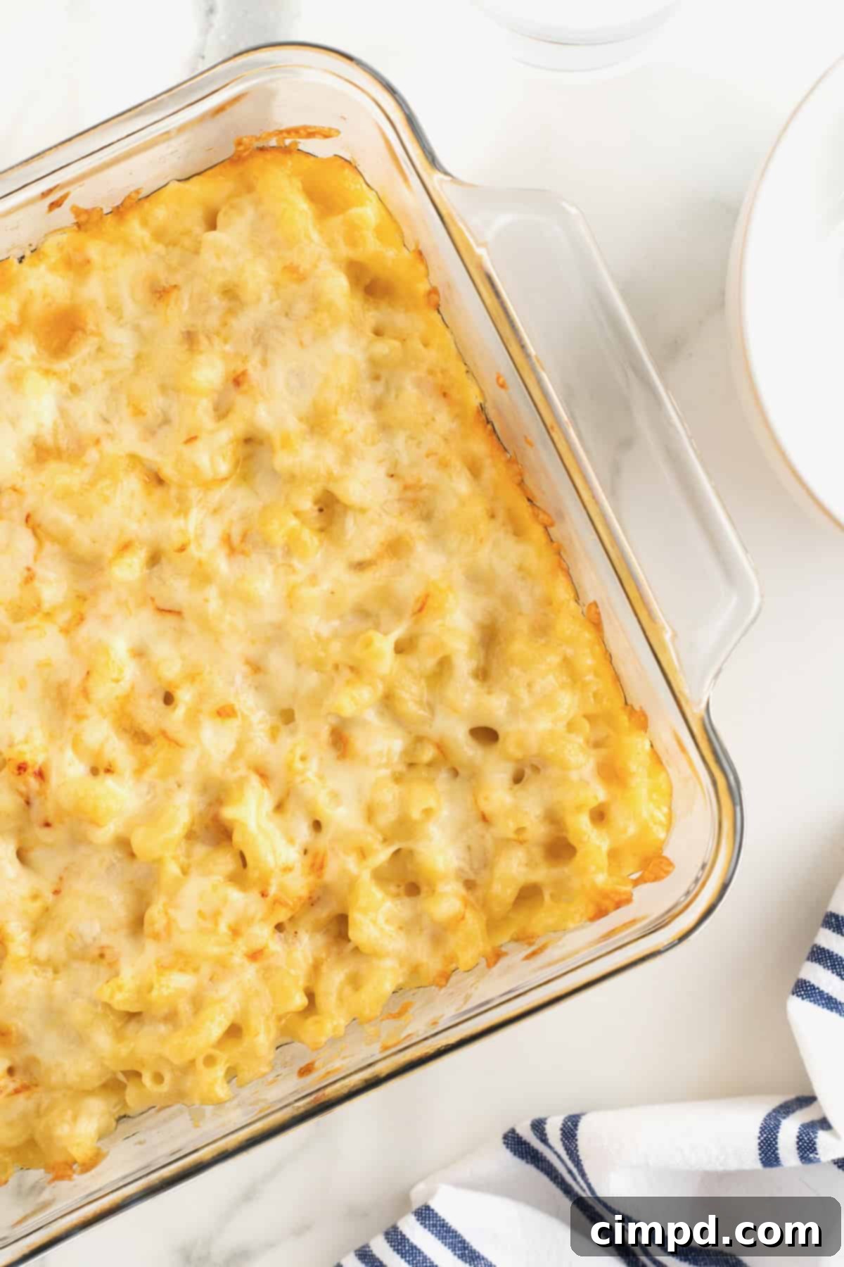 Creamy Muenster Mac and Cheese 11 A square glass dish filled with creamy Muenster Mac and Cheese, ready to be enjoyed.