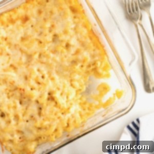 Creamy Muenster Mac and Cheese 13 A square glass dish filled with Muenster Mac and Cheese, a portion removed.
