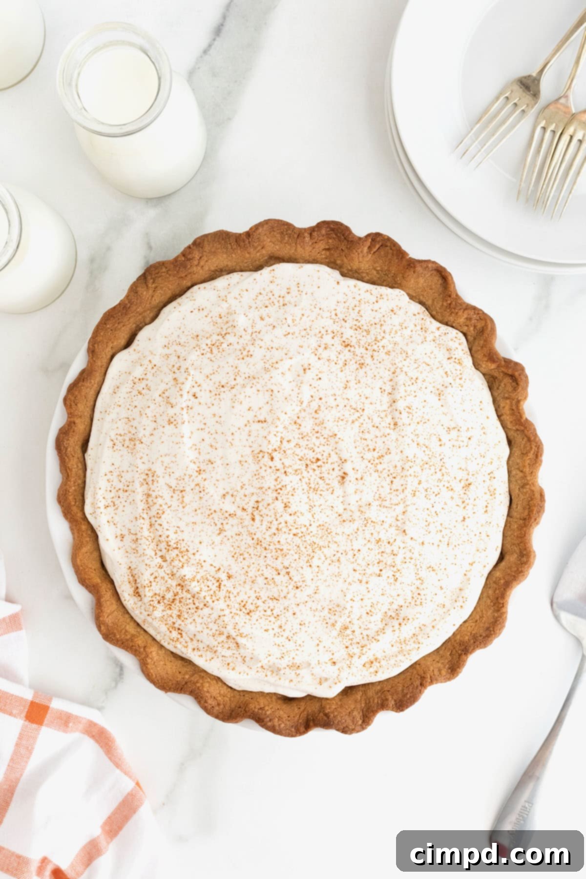 A finished pumpkin cream pie sprinkled with pumpkin pie spice.
