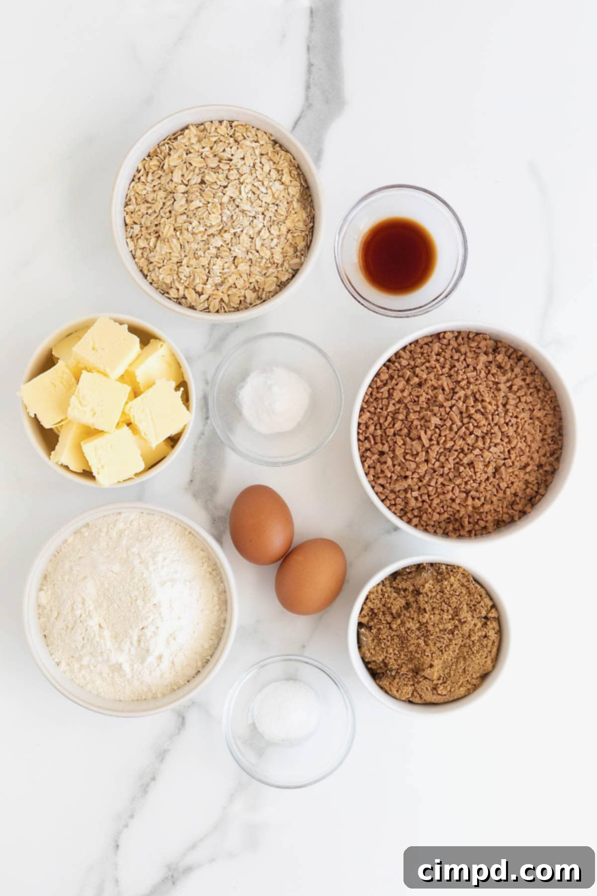 A vibrant flat lay showcasing all the essential ingredients and baking tools laid out neatly to make Brown Sugar Oatmeal Toffee Crunch Cookies, ready for baking.