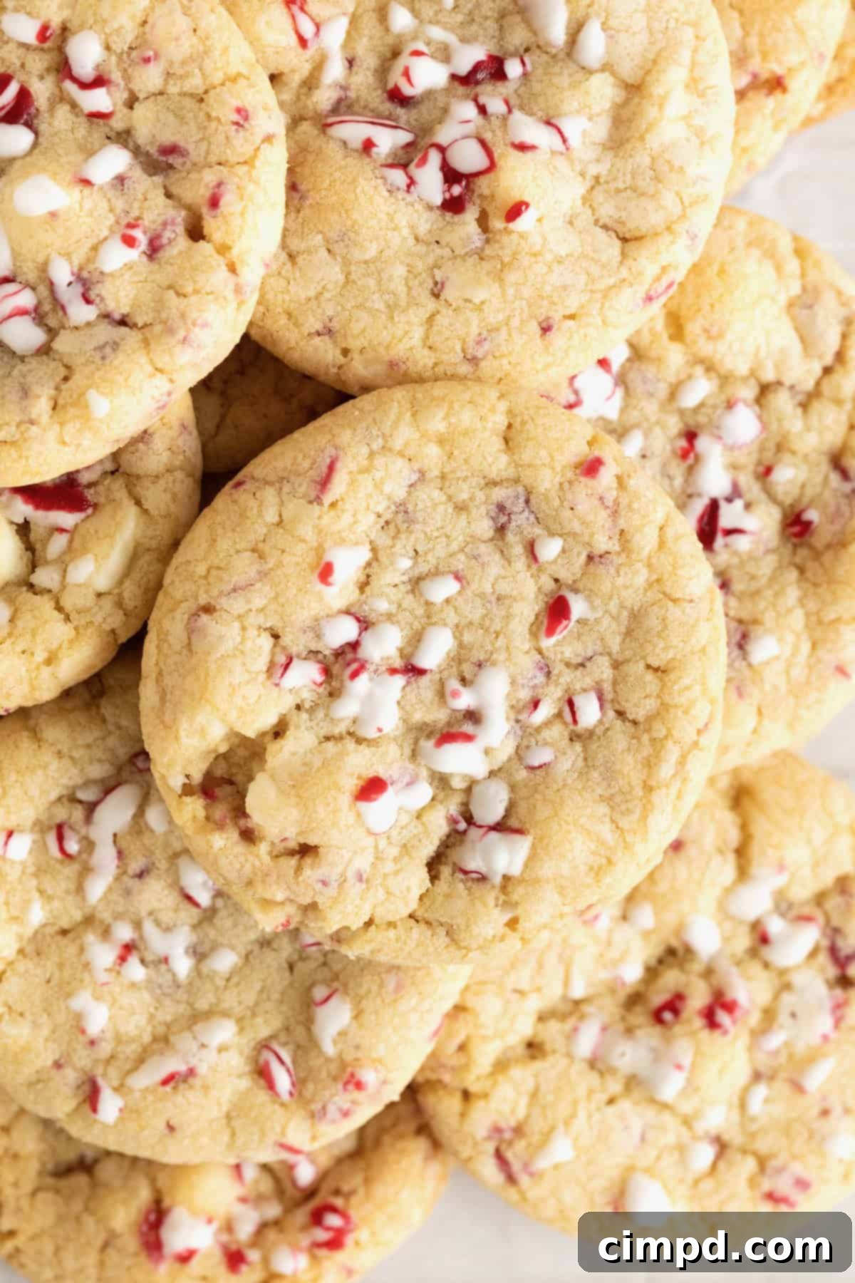 Dreamy Peppermint White Chocolate Pudding Cookies 5 A tempting pile of freshly baked cookies, generously topped with vibrant bits of peppermint, creating a stunning visual and inviting texture.