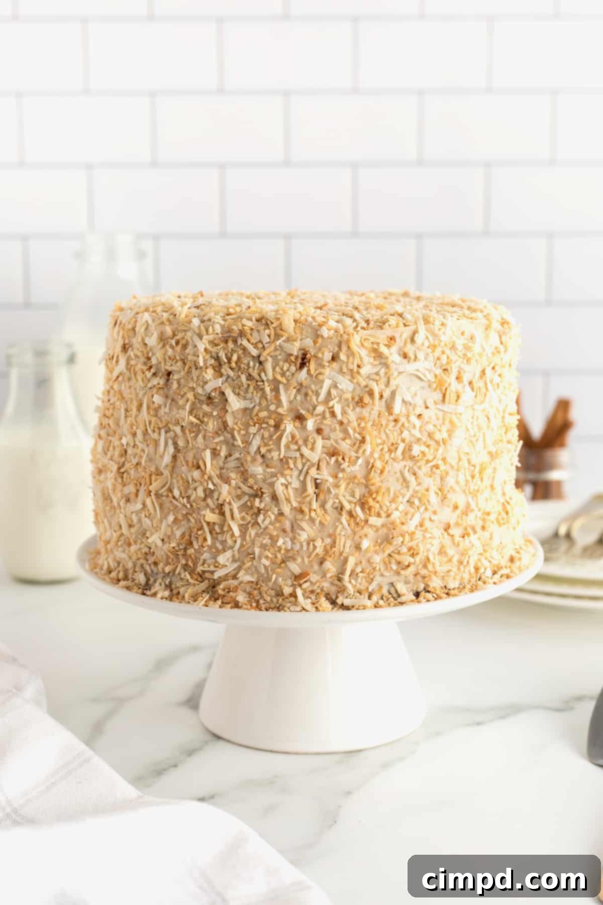 Warmly Spiced Carrot Coconut Cake with Tangy Cream Cheese Frosting 12 Coconut Carrot Cake with Cinnamon Cream Cheese Frosting by The BakerMama