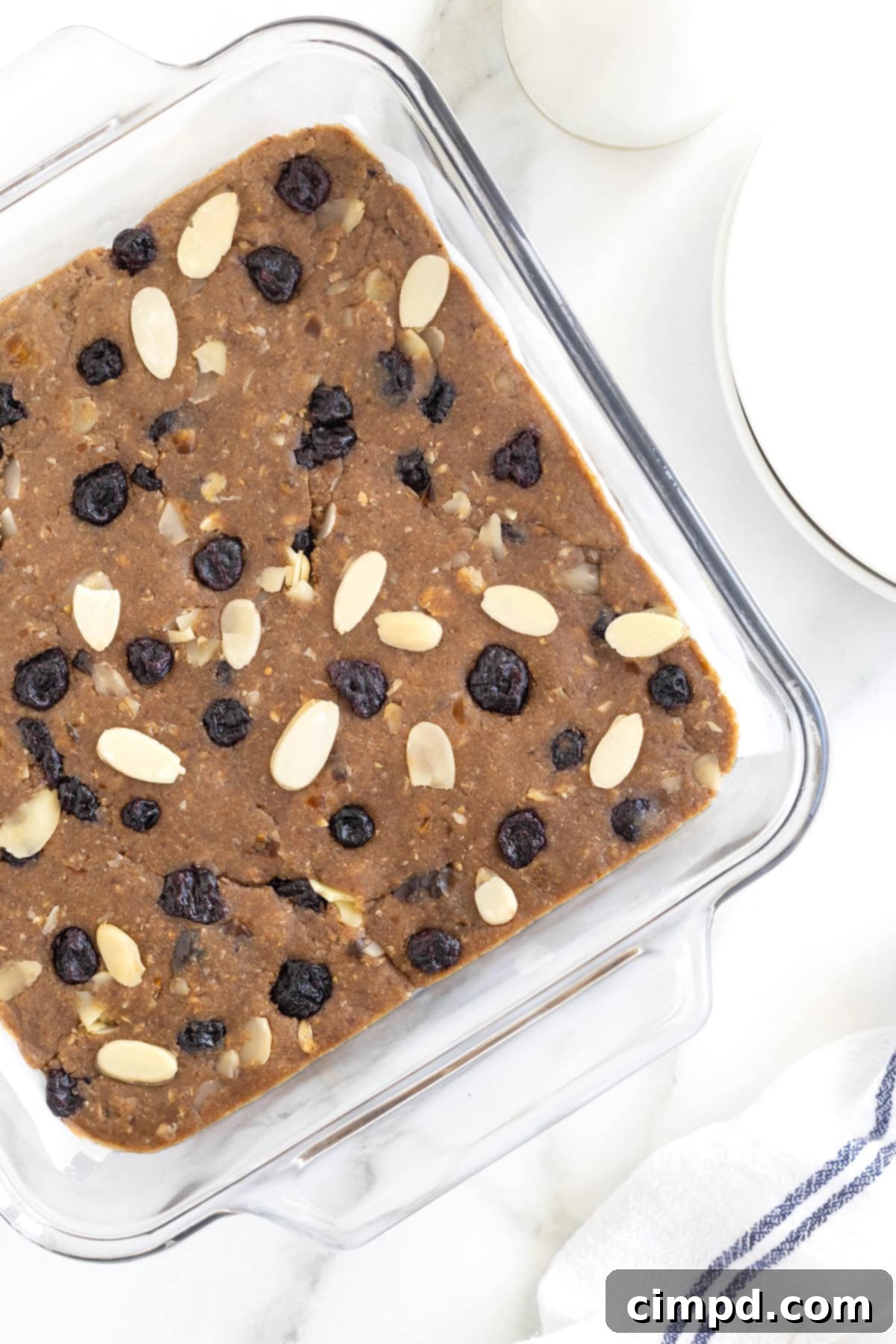 Sunrise Blueberry Banana Almond Bars 9 A pristine square glass baking dish, now empty, with remaining traces of the delicious breakfast bars, ready for another batch or clean-up.