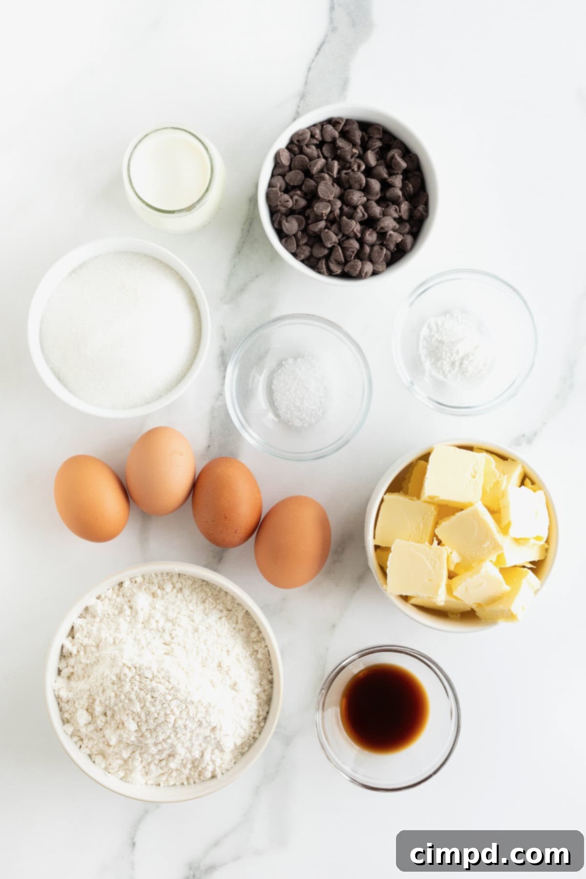 Decadent Chocolate Chip Pound Cake 5 Ingredients to make chocolate chip pound cake in small glass dishes on a white marble counter.