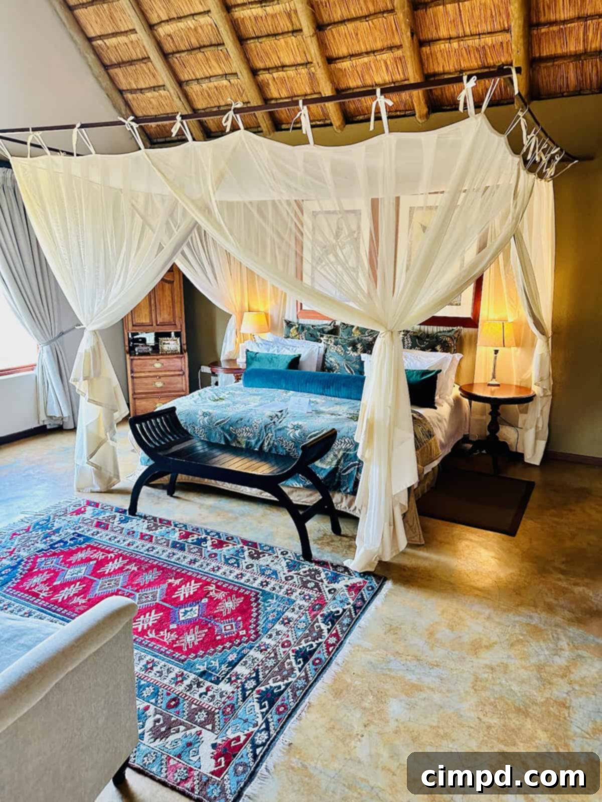 Exploring the Wonders of South Africa and Zambia 6 A large bed with mosquito netting draped over it in a luxurious safari lodge.