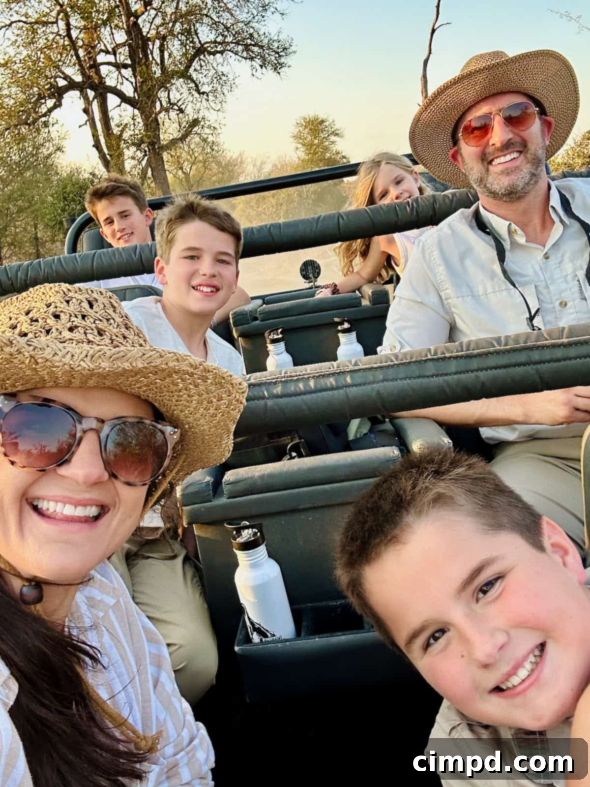 Exploring the Wonders of South Africa and Zambia 9 The Brown Family taking a selfie in a safari jeep, smiling during their game drive.