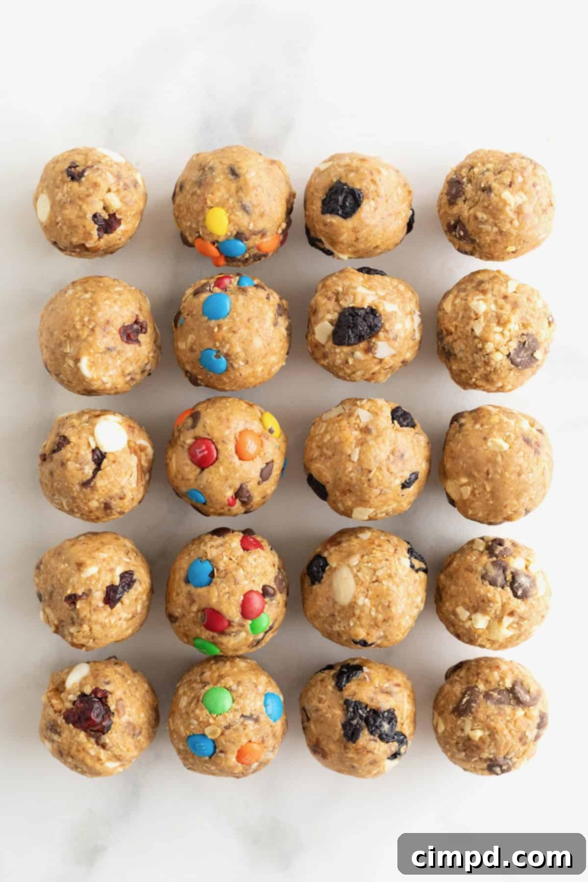 Wholesome Energy Bites 6 Energy bites with dried cranberries and white chocolate chips, mini M&Ms, dried blueberries, and chocolate chips.